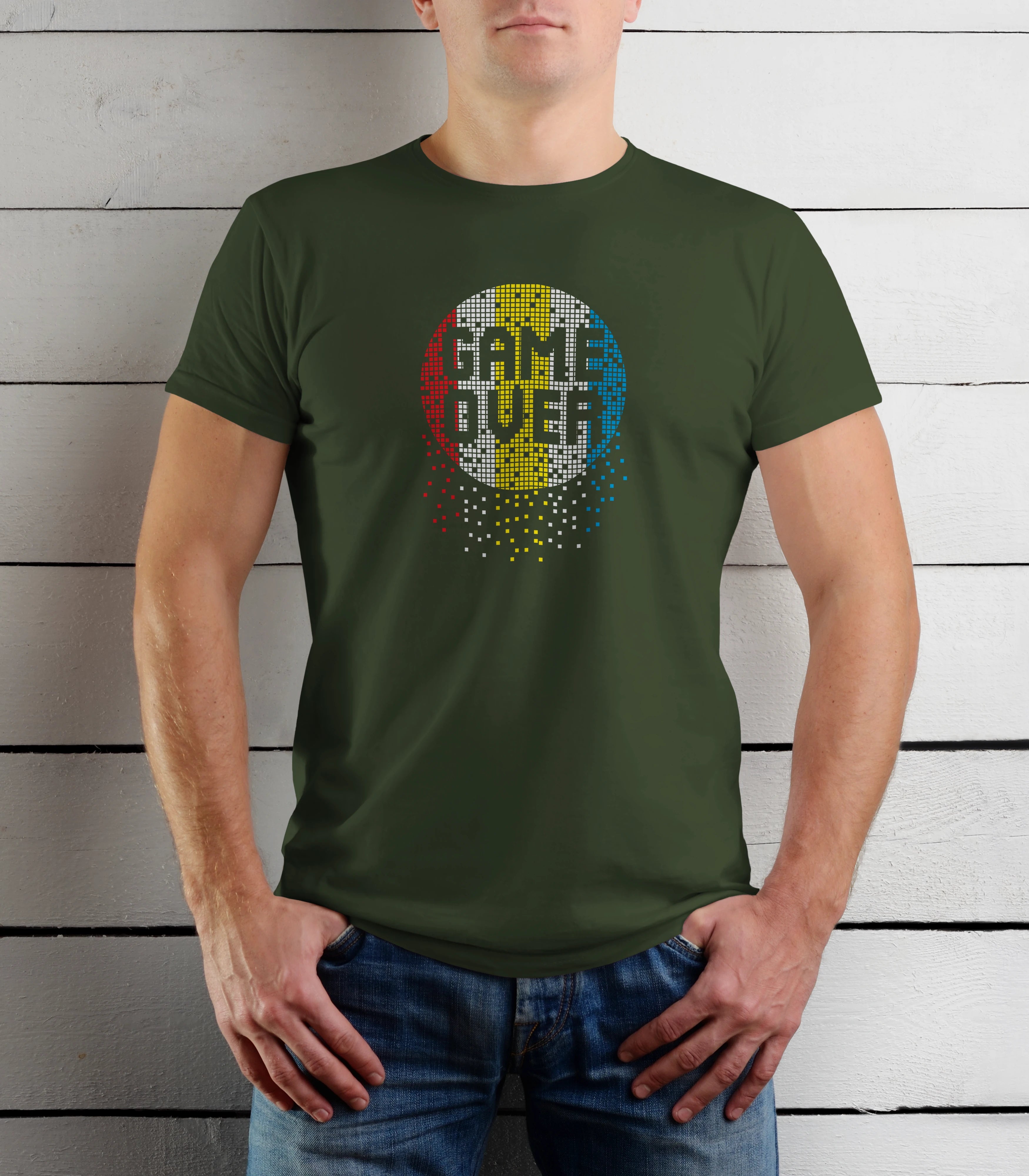 Person wearing a green t-shirt with a colorful graphic design on a wooden background