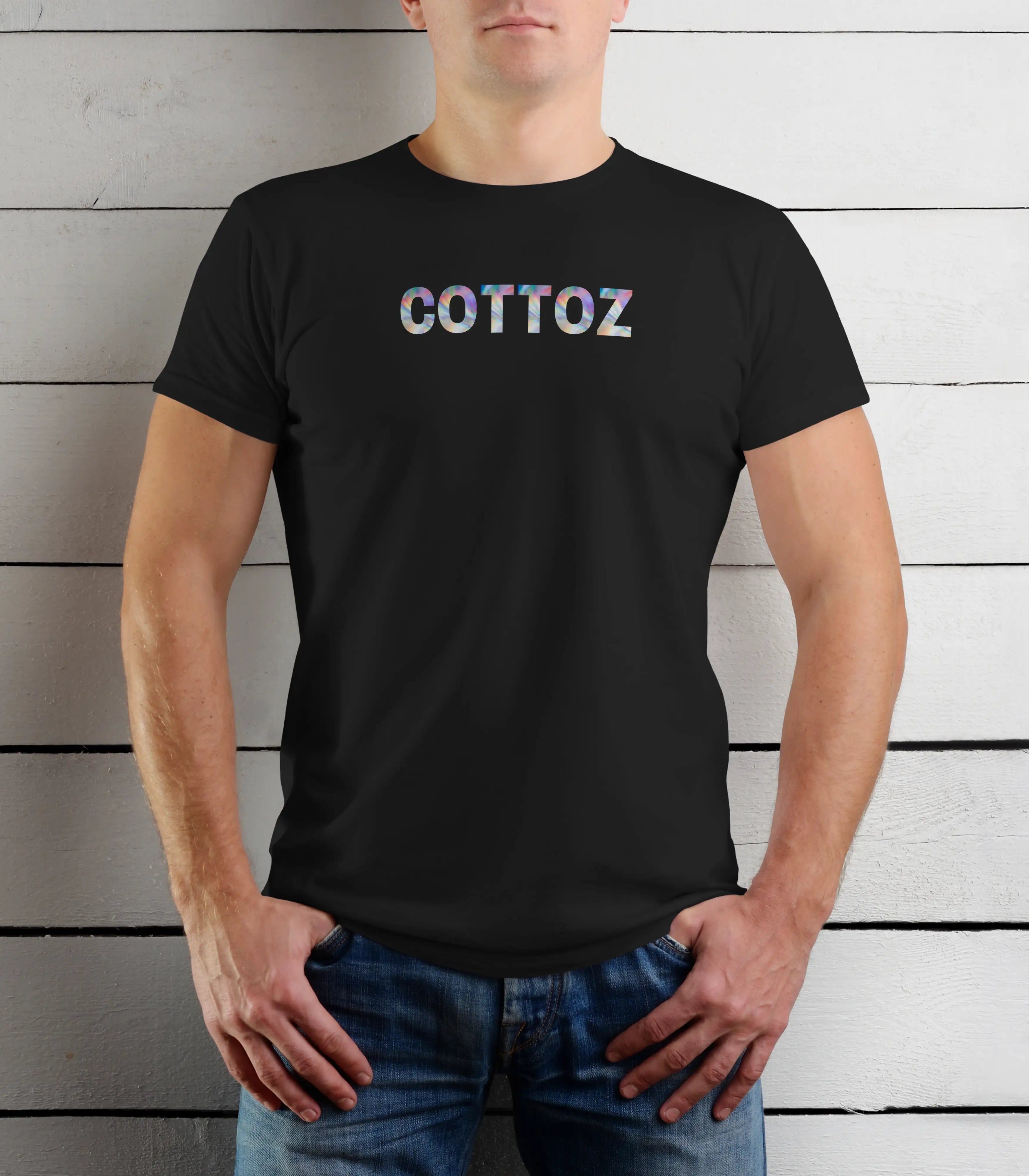 Person wearing a black t-shirt with 'COTTOZ' printed on it against a wooden background