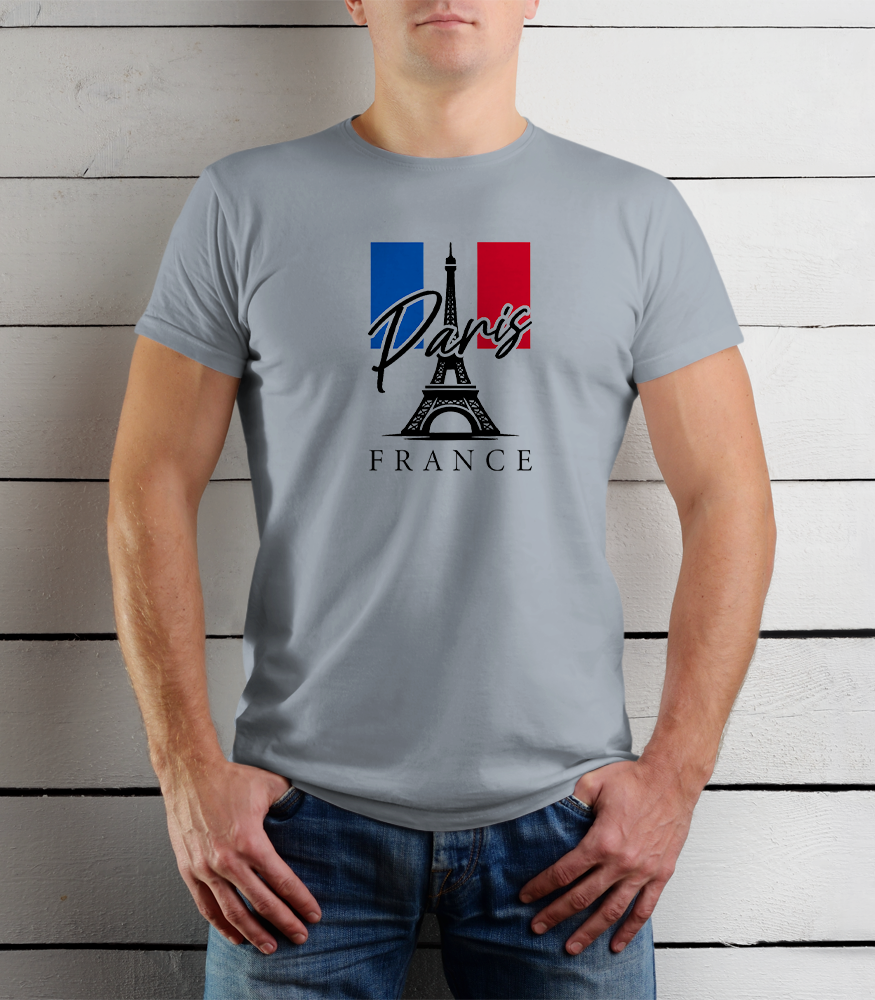 Person wearing a gray t-shirt with Paris and France design against a wooden background