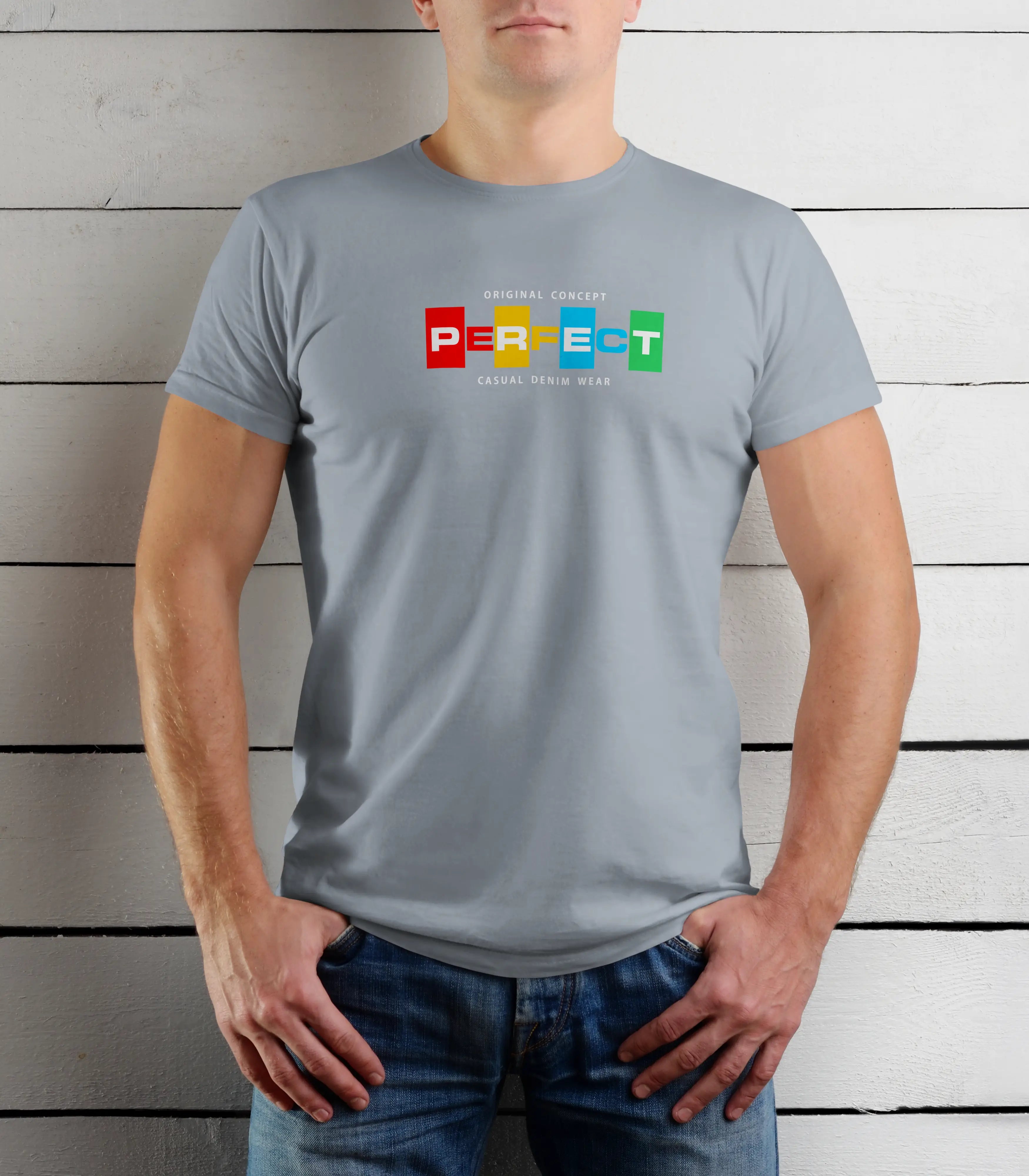 Person wearing a gray t-shirt with colorful text design against a wooden background