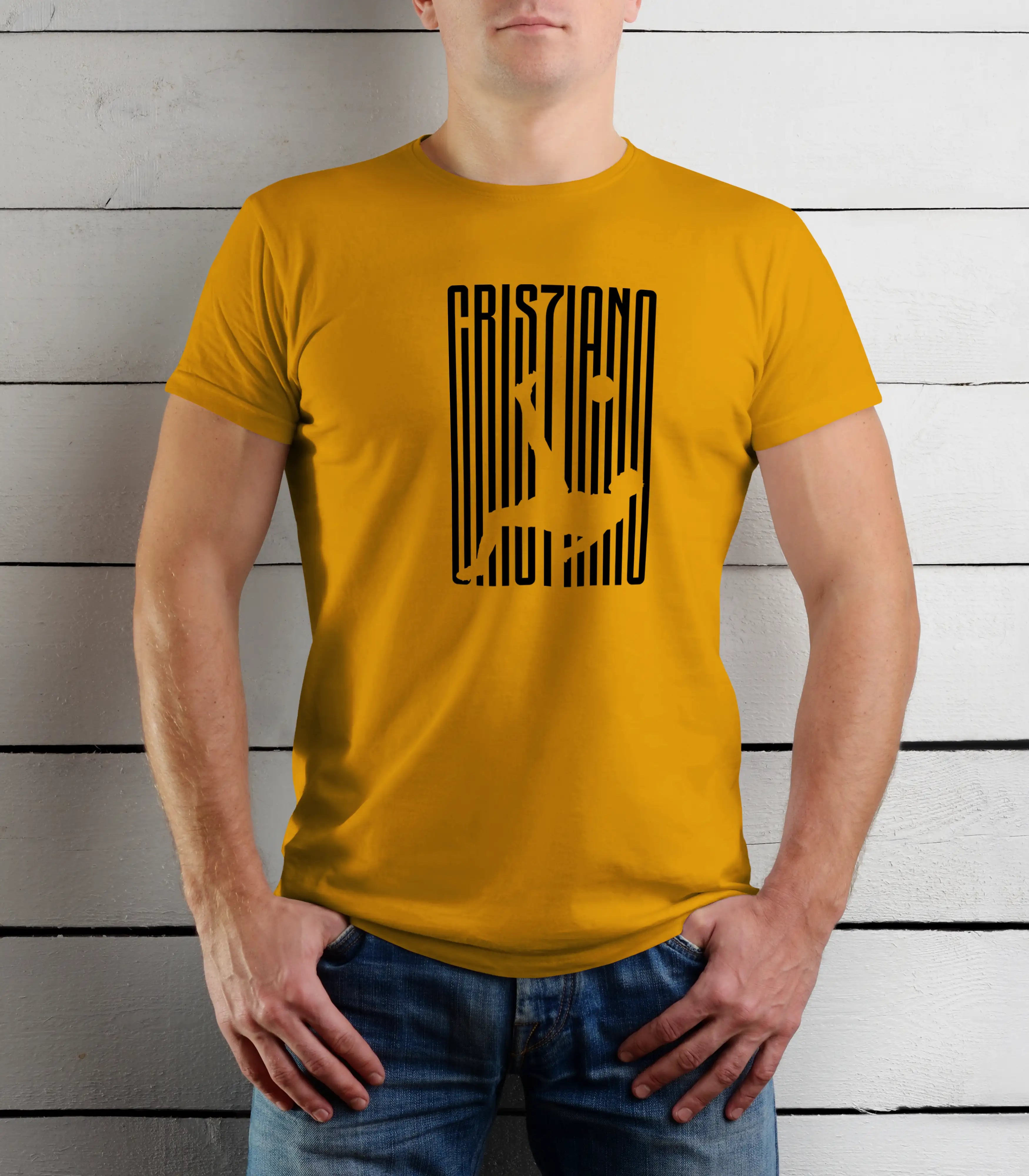 Person wearing a mustard yellow t-shirt with black text design against a wooden background