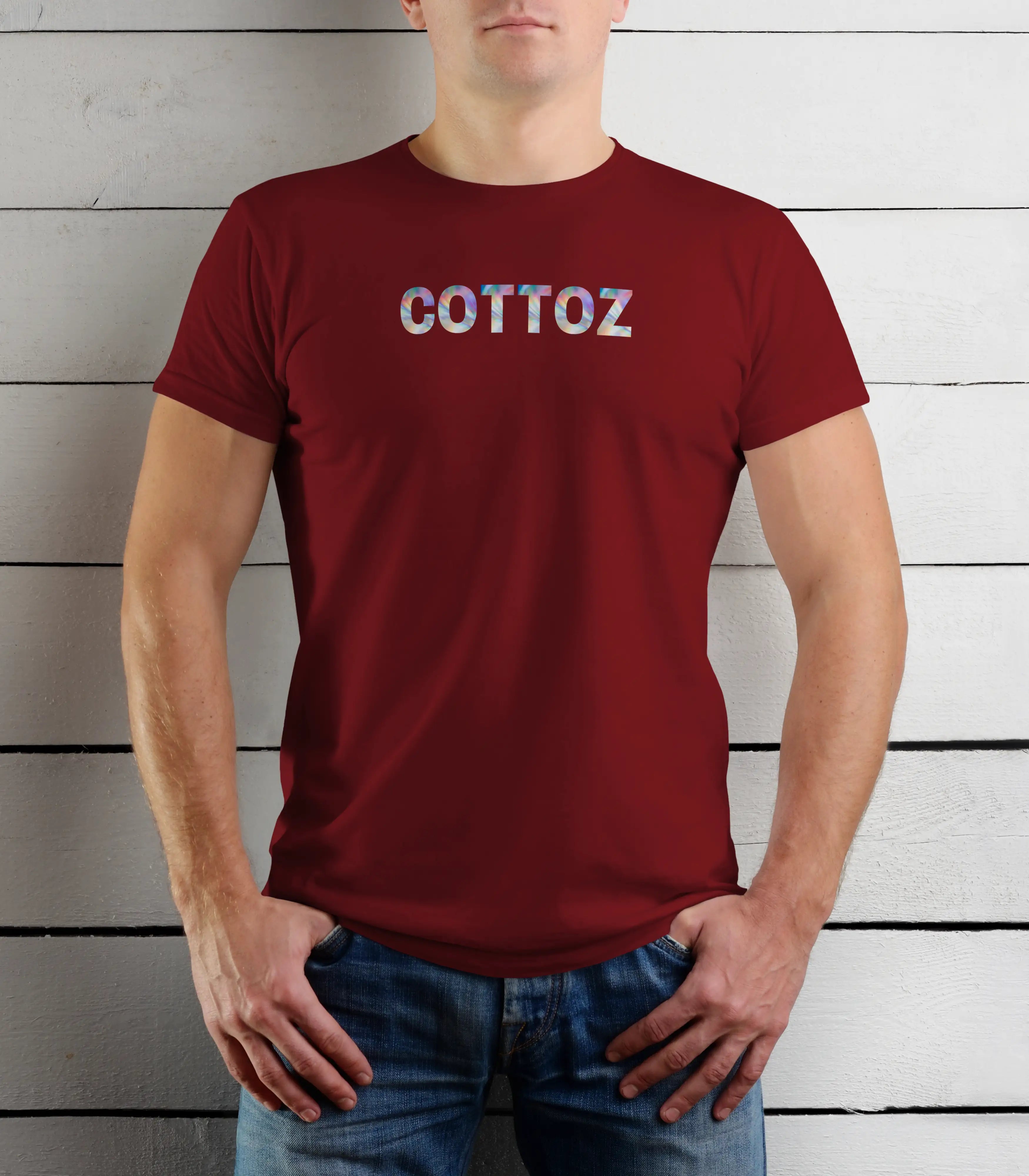 Person wearing a red t-shirt with 'COTTOZ' printed on it against a wooden background