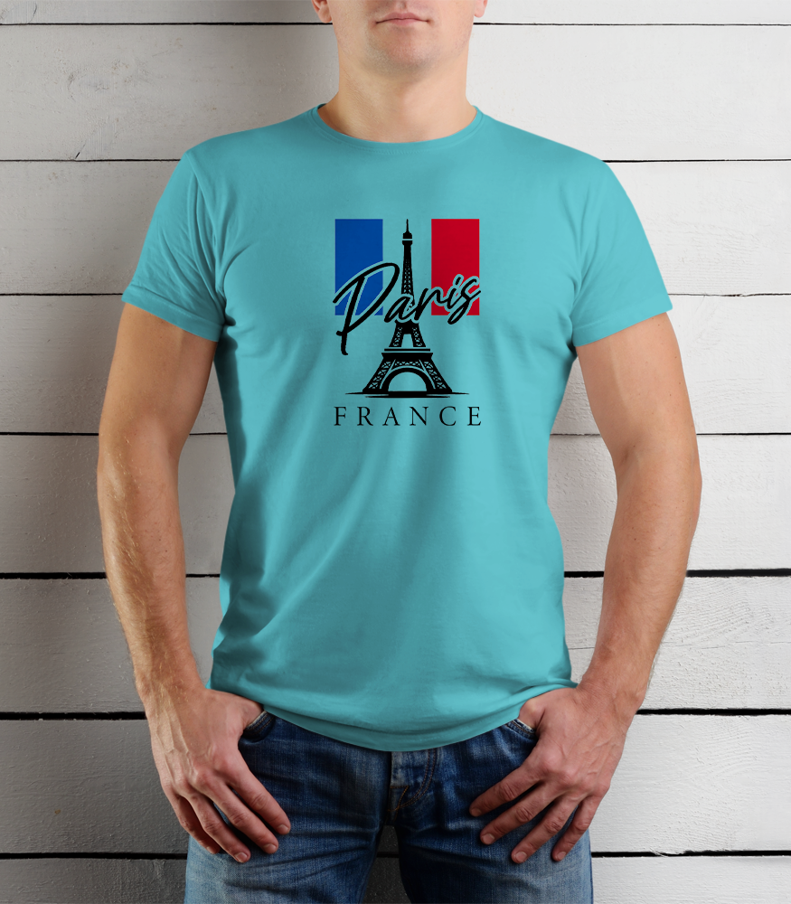 Person wearing a turquoise t-shirt with Paris and France design against a wooden background