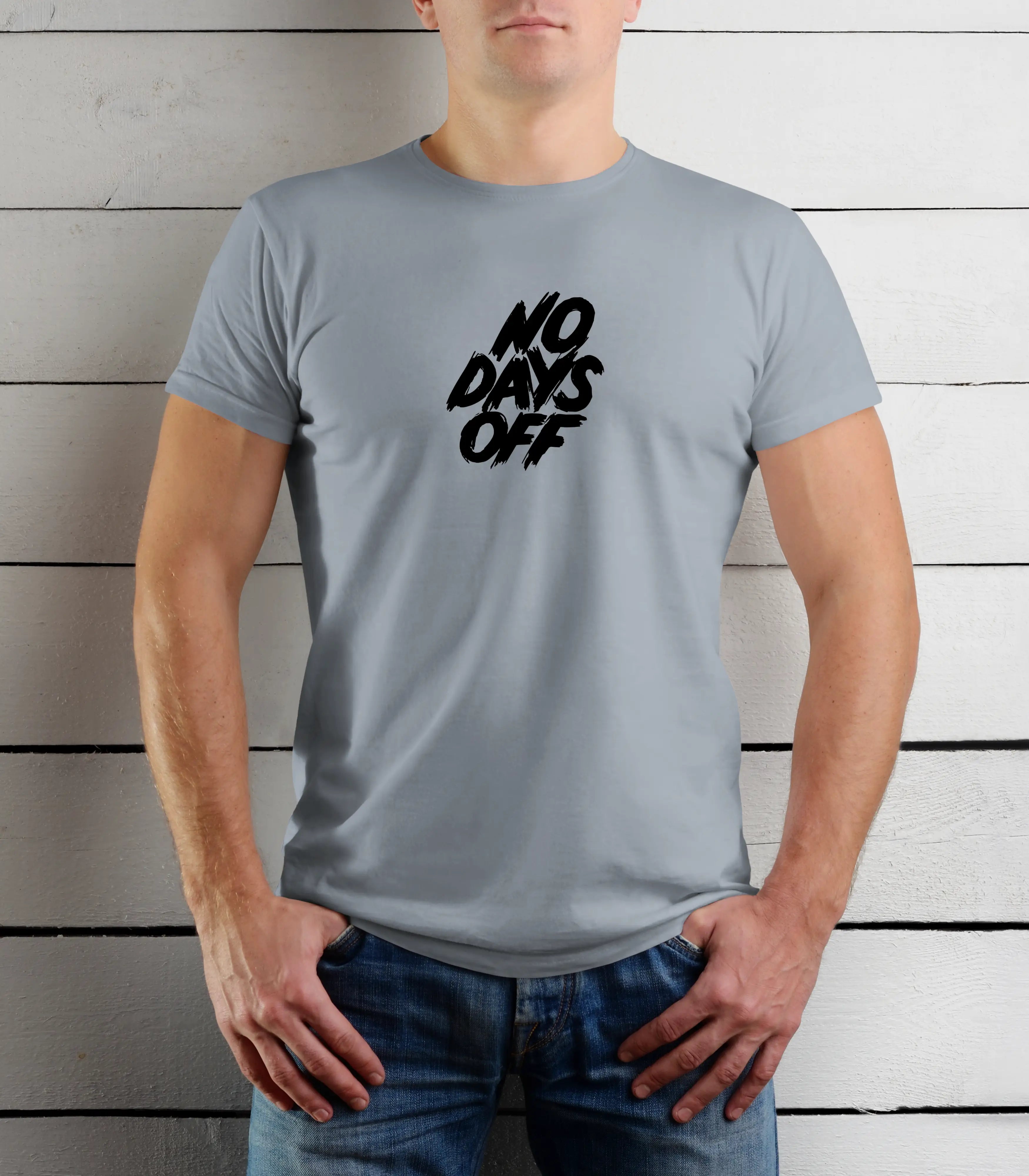 Person wearing a gray t-shirt with 'NO DAYS OFF' text against a wooden background