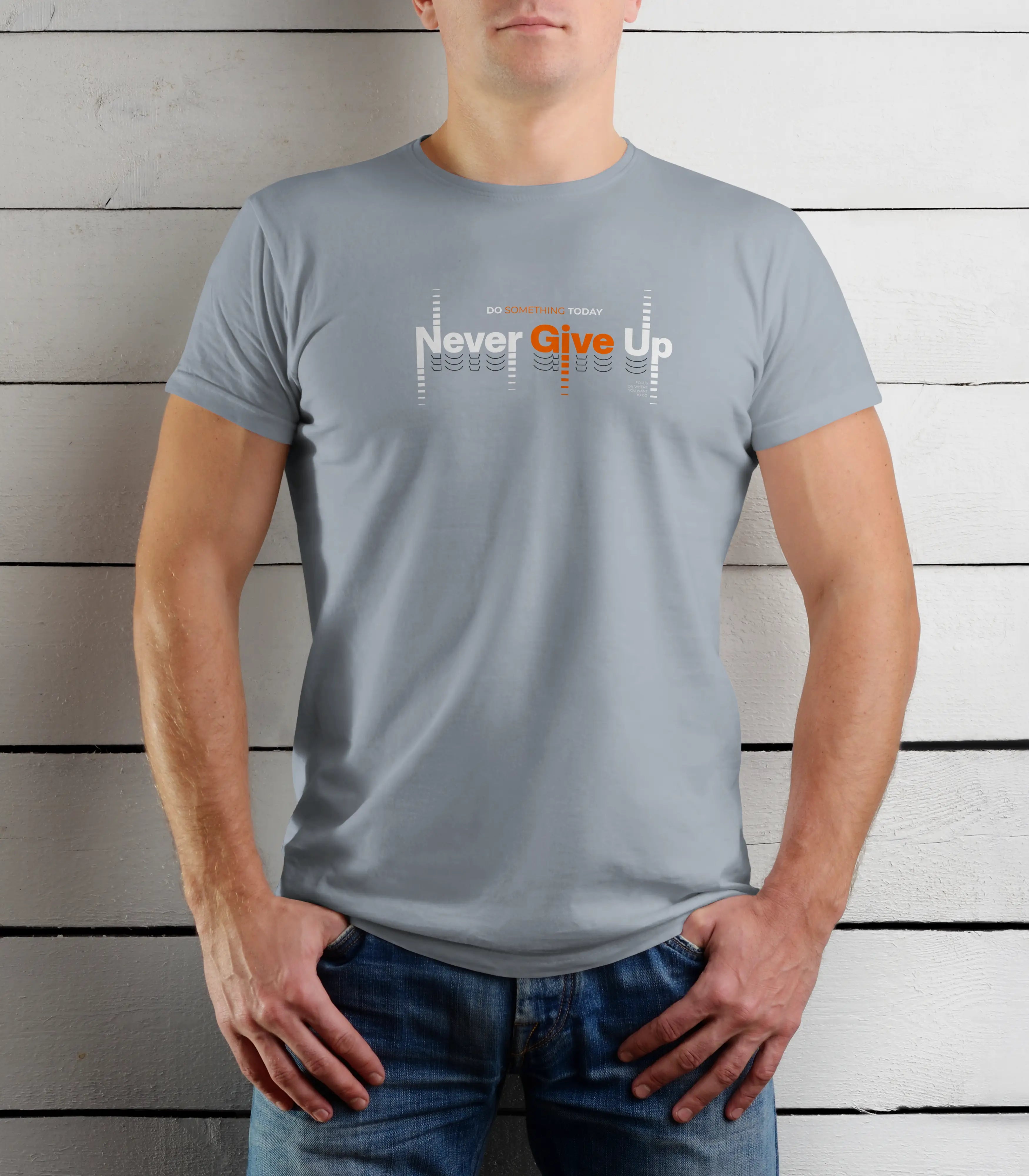 Person wearing a gray t-shirt with 'Never Give Up' text against a wooden background