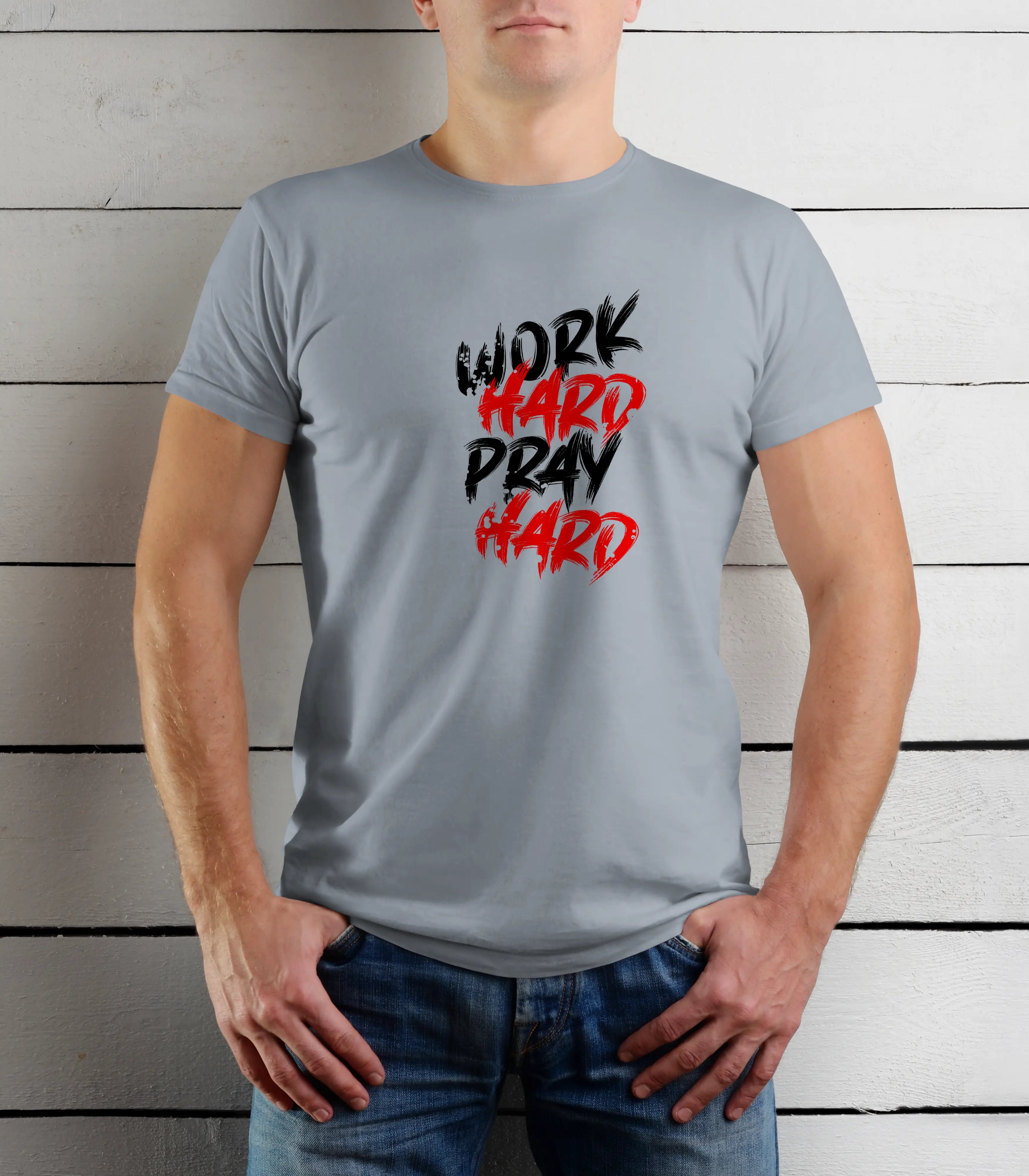 Person wearing a gray t-shirt with 'Work Hard Pray Hard' text in black and red on a wooden background