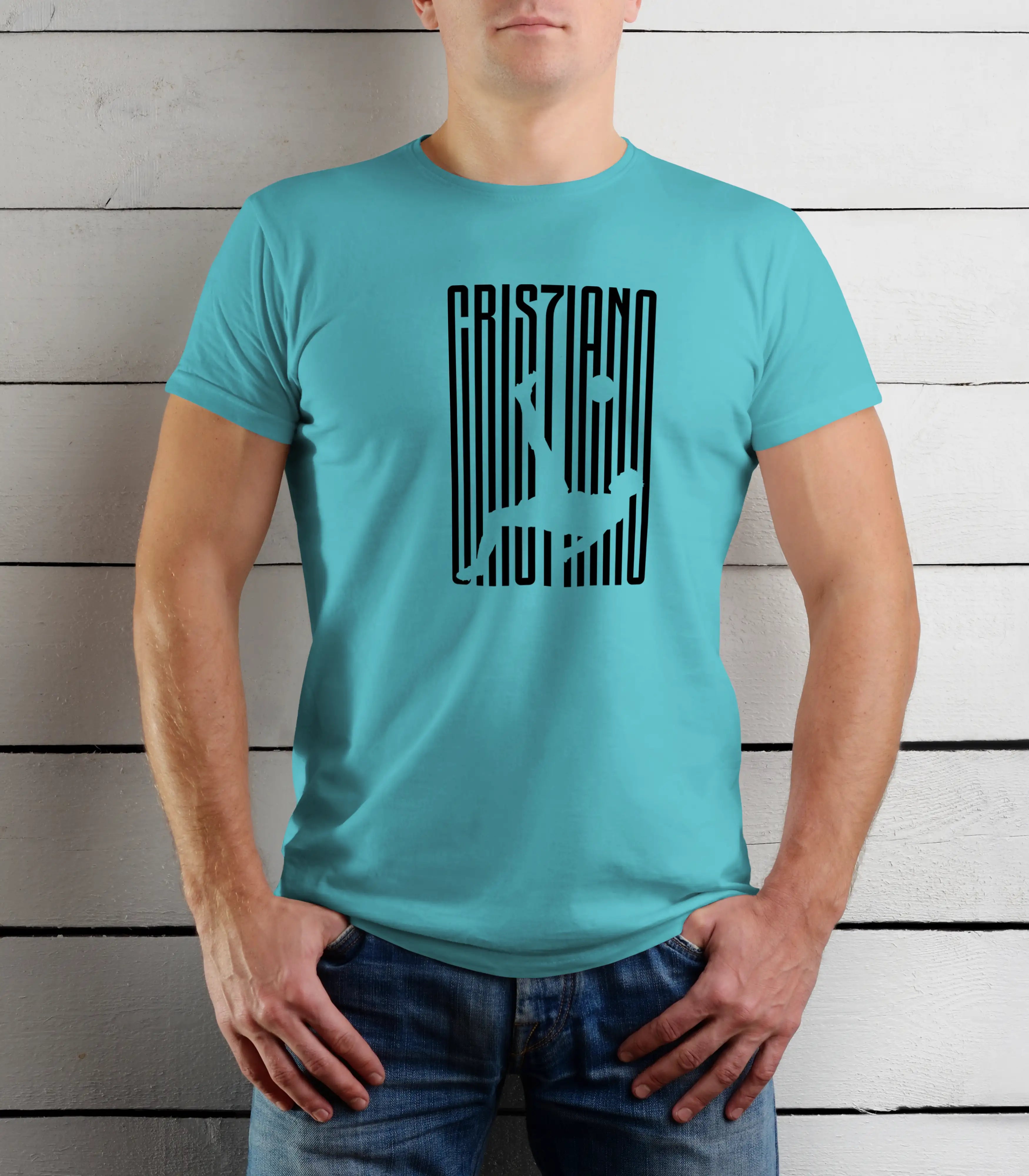 Person wearing a turquoise t-shirt with black text design against a wooden background