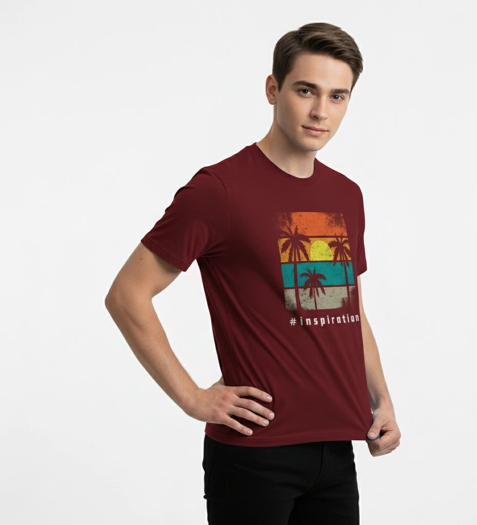 Man wearing a maroon t-shirt with a colorful graphic design on a white background