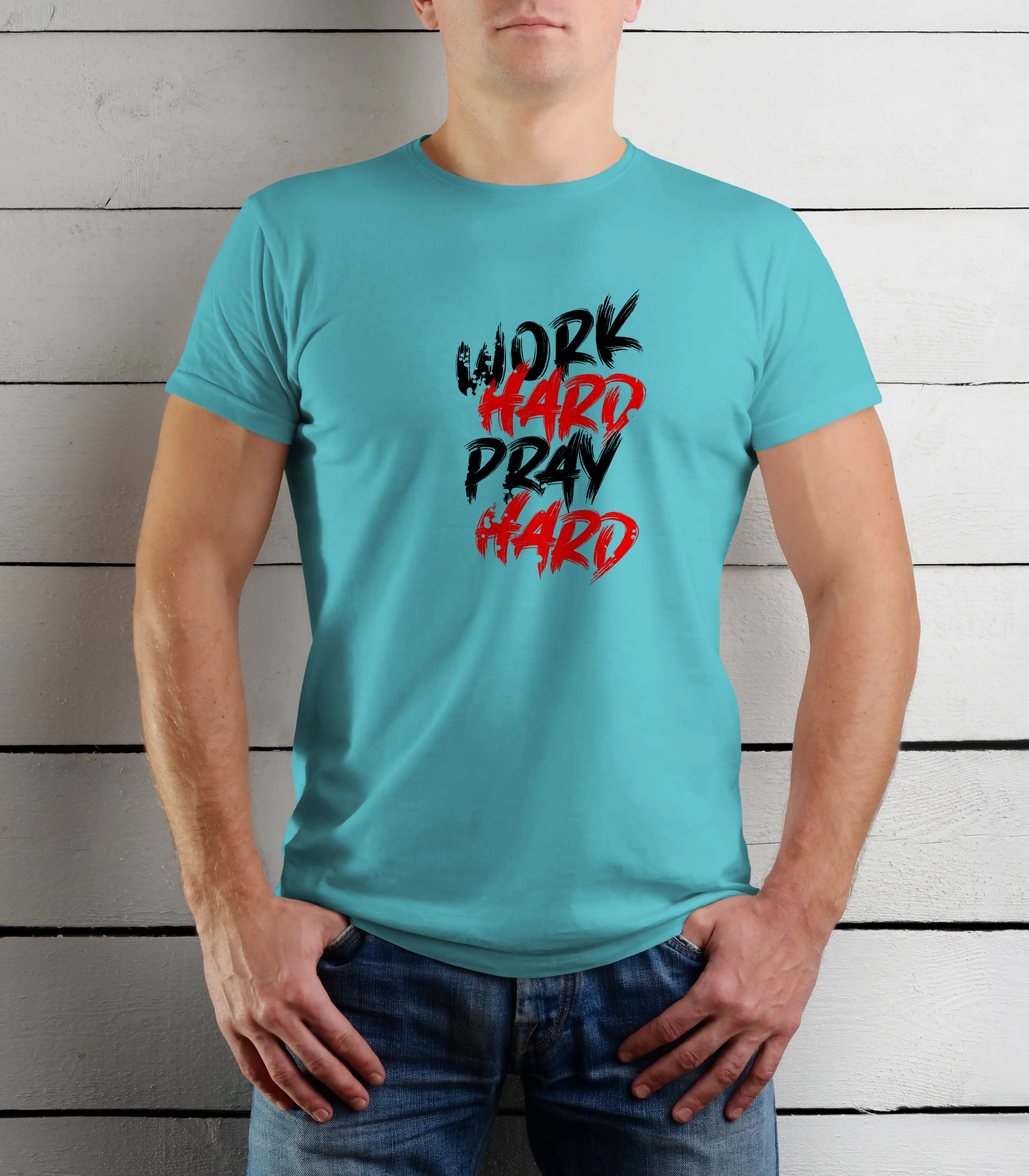Person wearing a turquoise t-shirt with motivational text against a wooden background