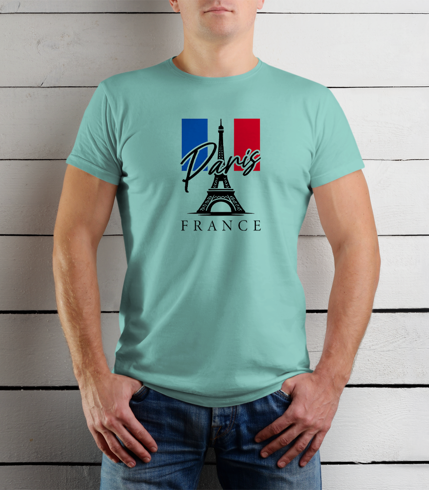 Person wearing a light blue t-shirt with Paris and France design against a wooden background