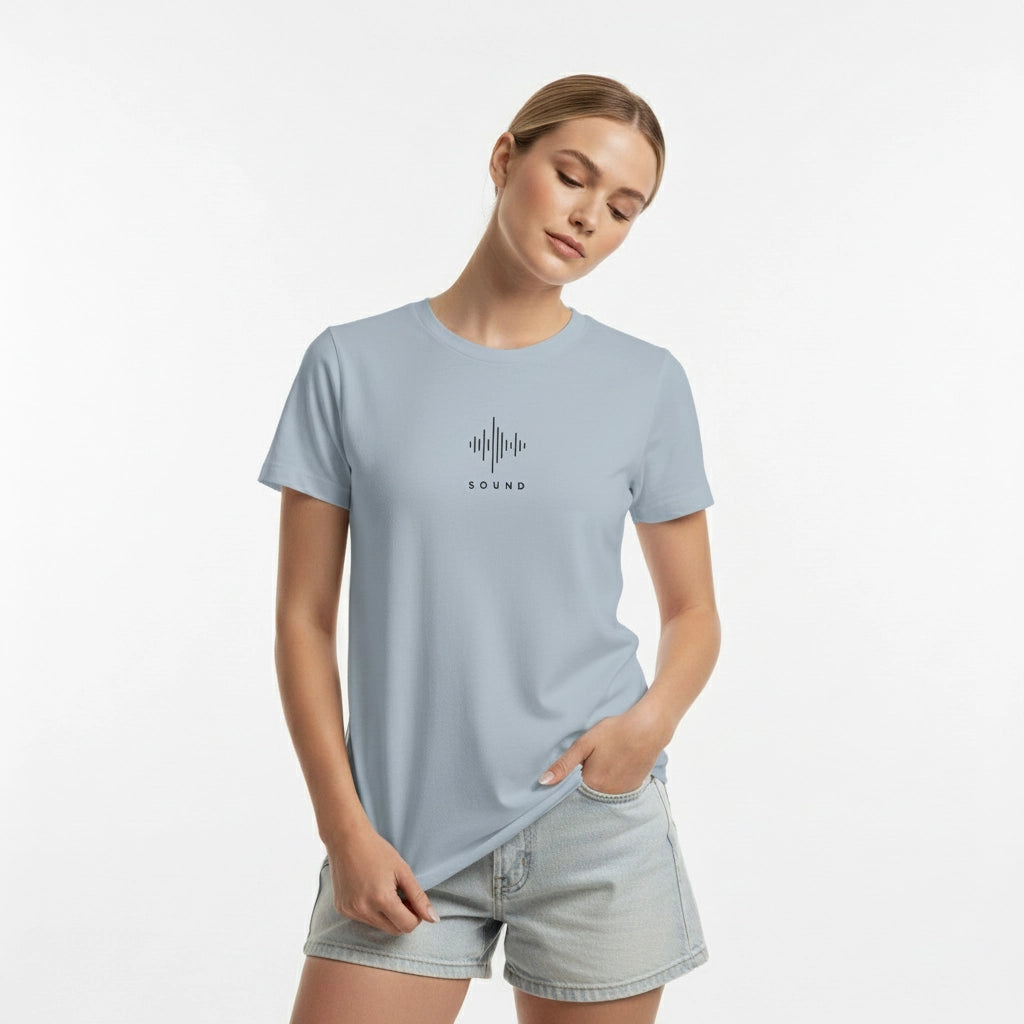 Woman wearing a light blue t-shirt with a graphic design on a white background