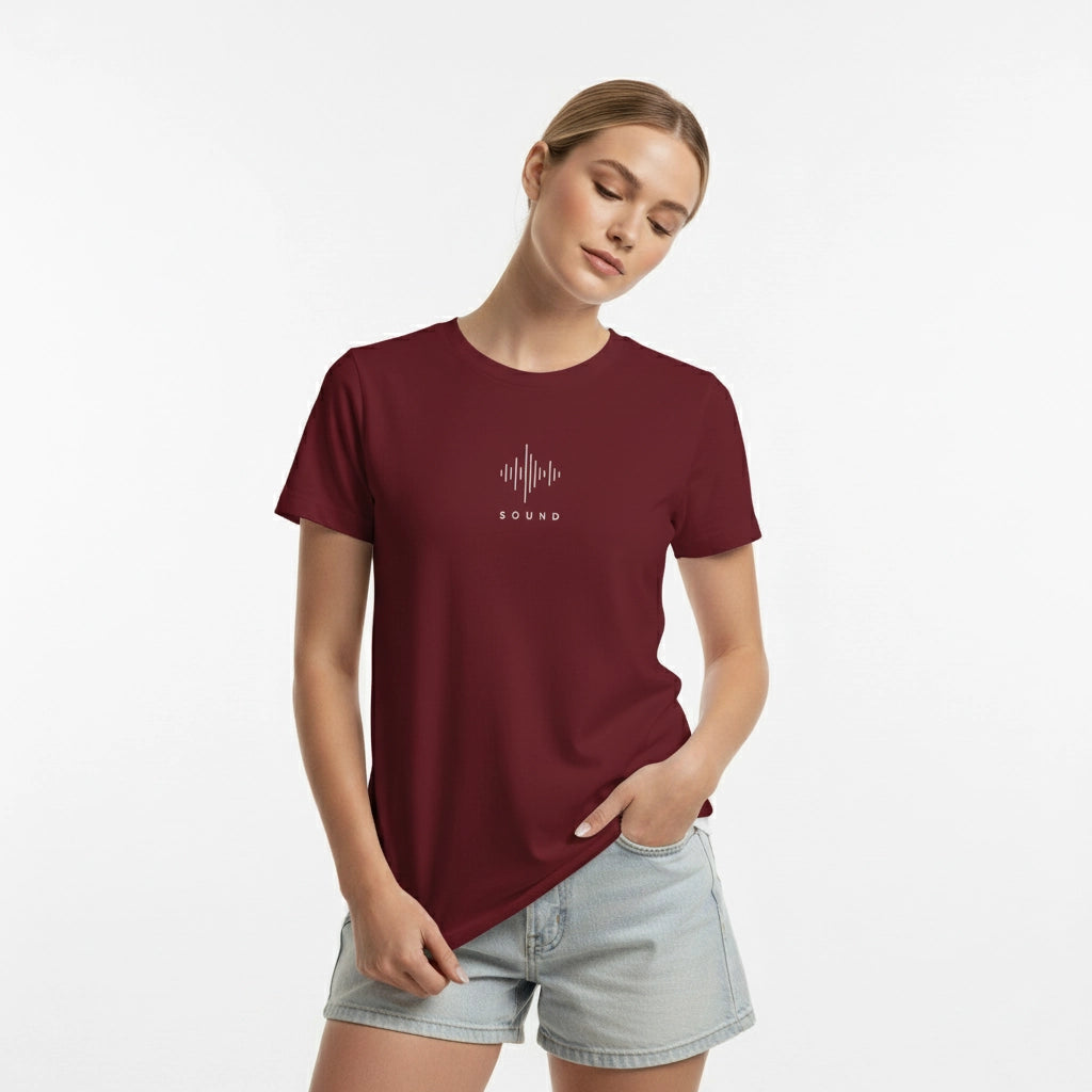 Woman wearing a maroon t-shirt with a graphic design on a white background