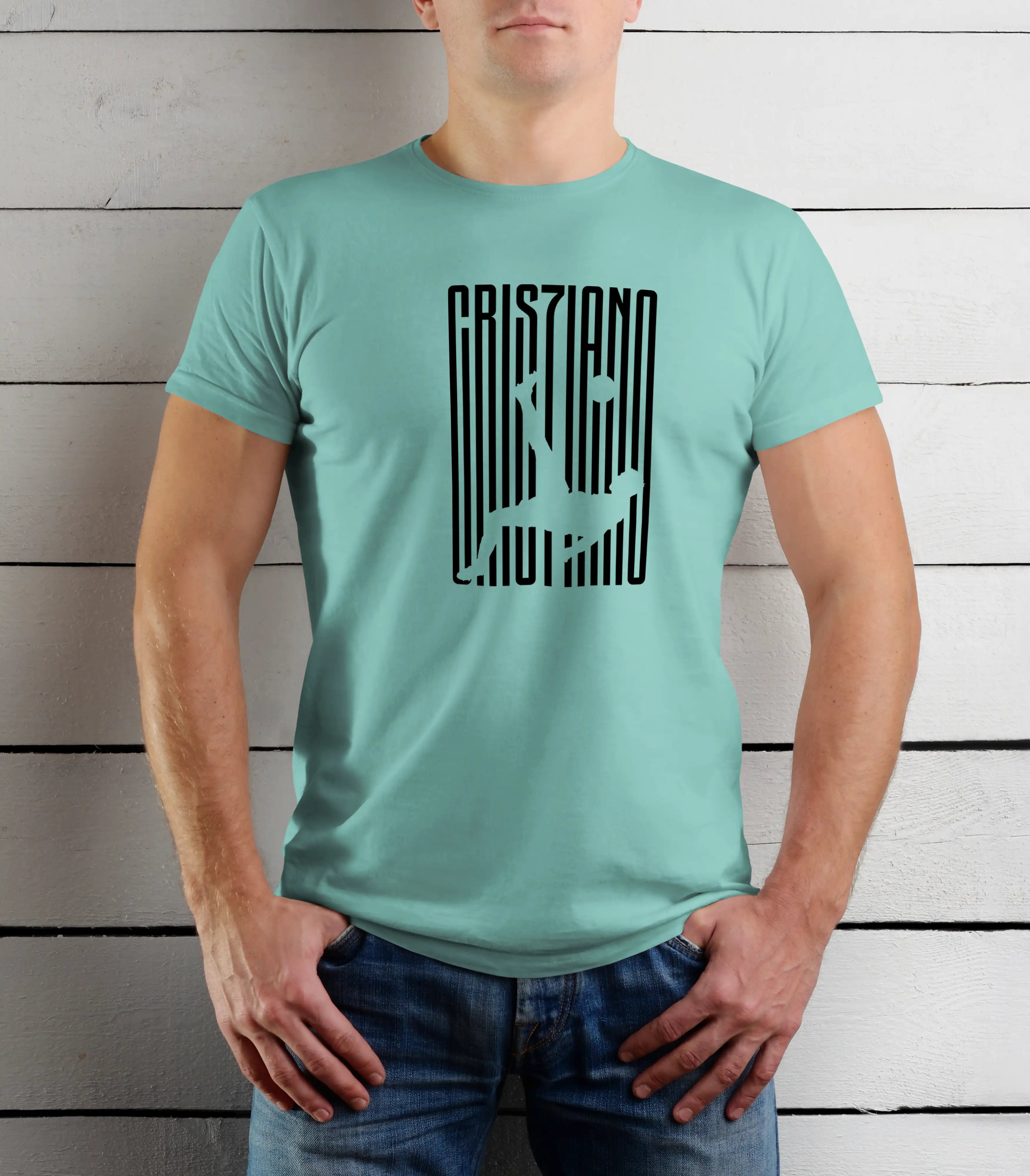 Person wearing a light blue t-shirt with black text design against a wooden background