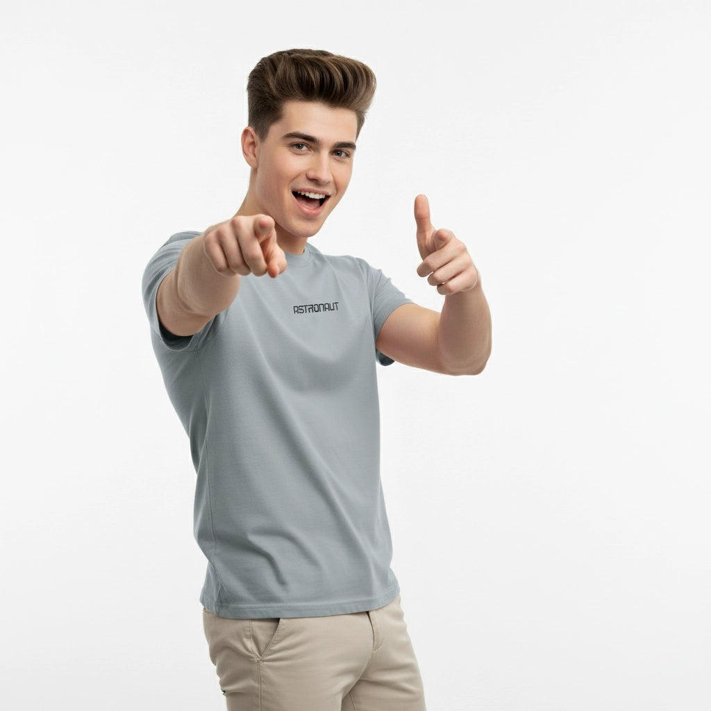 Person wearing a gray t-shirt with a brand logo, pointing forward on a white background
