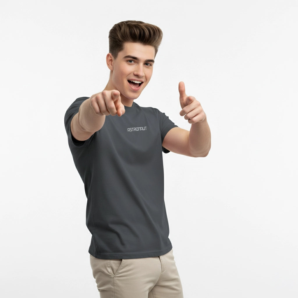 Man wearing a gray t-shirt with a brand logo, pointing forward on a white background