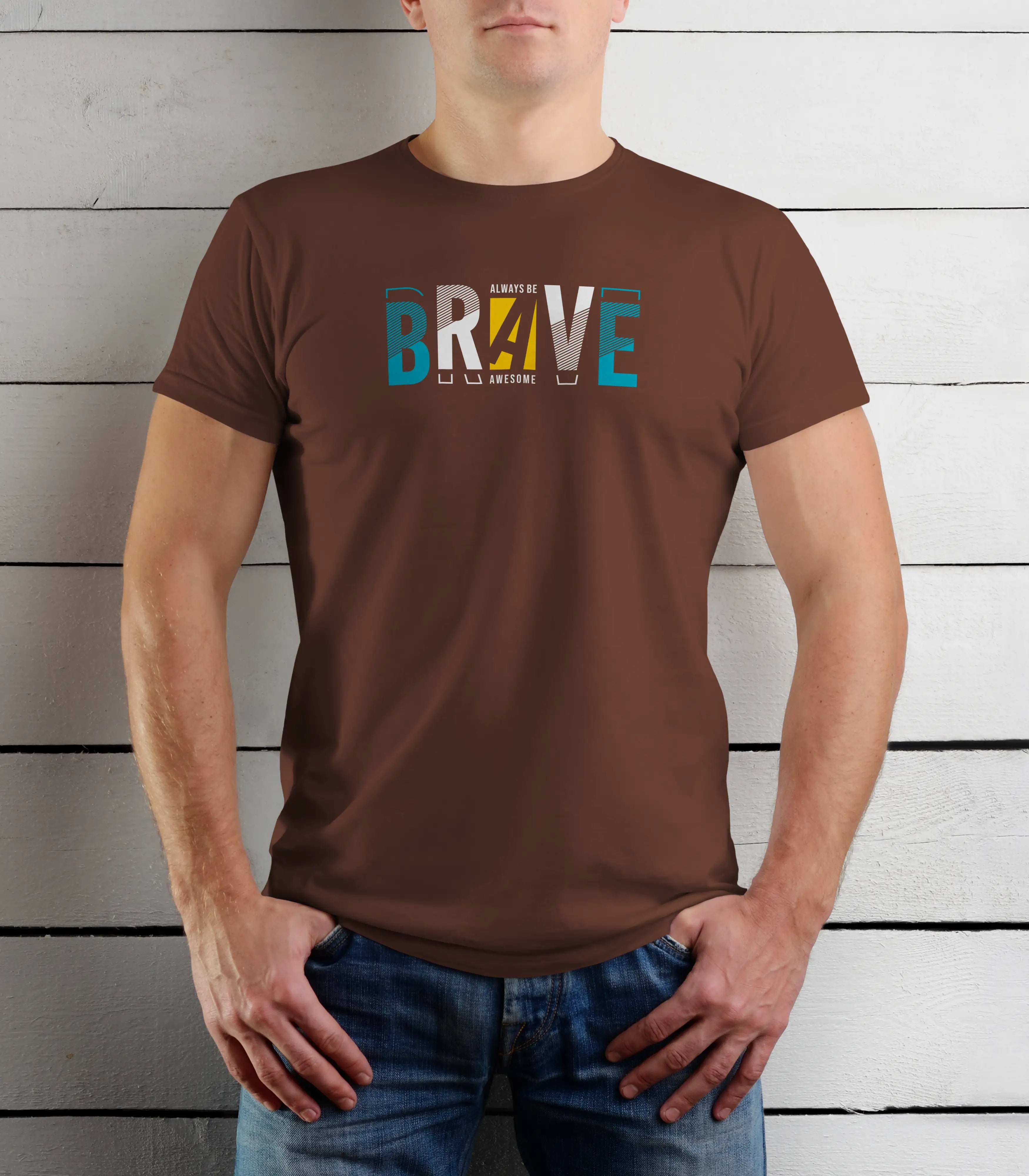 Person wearing a brown t-shirt with 'BRVE' printed on it against a wooden background