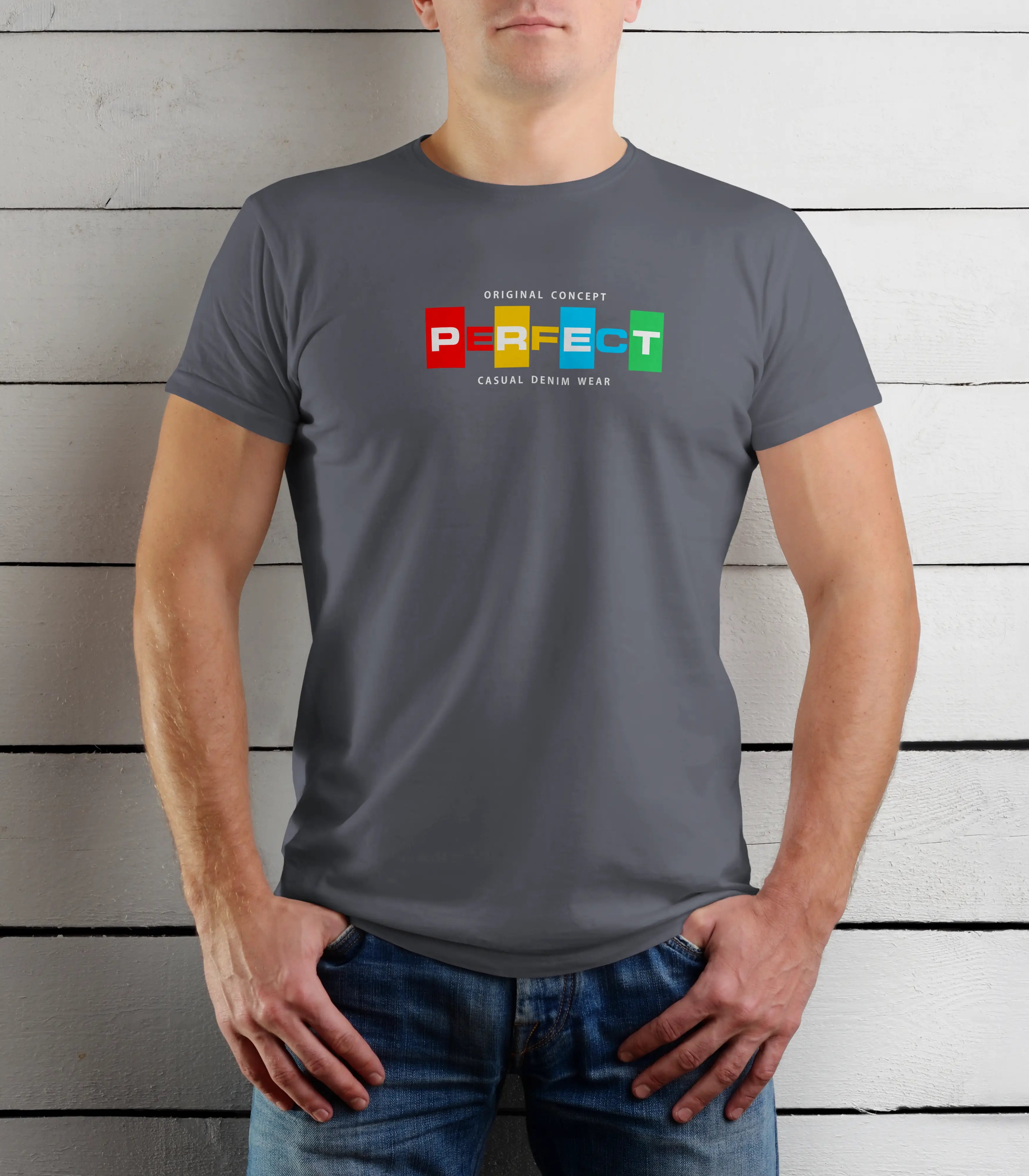 Person wearing a gray t-shirt with colorful text design against a wooden background