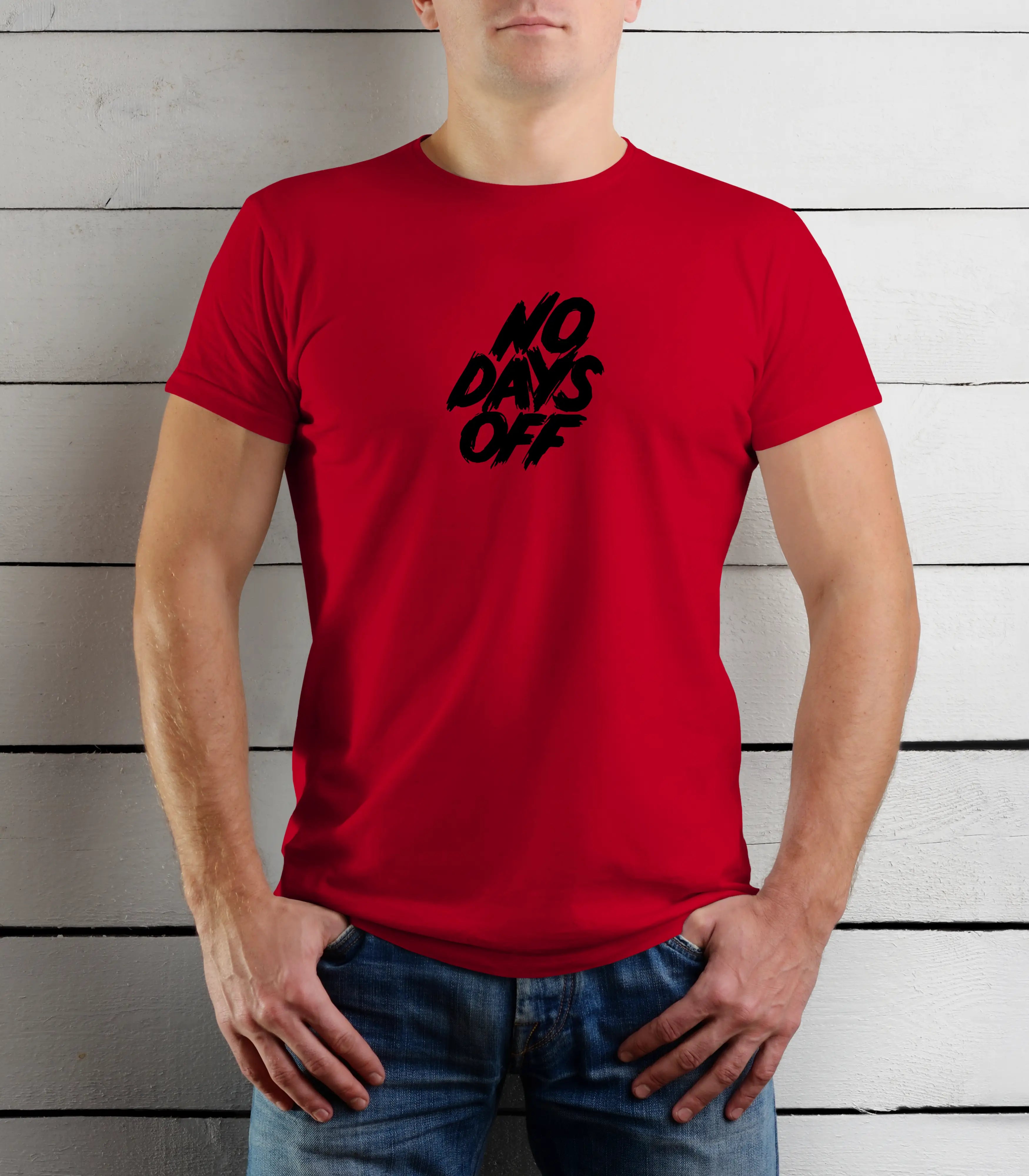 Person wearing a red t-shirt with 'NO DAYS OFF' text against a wooden background