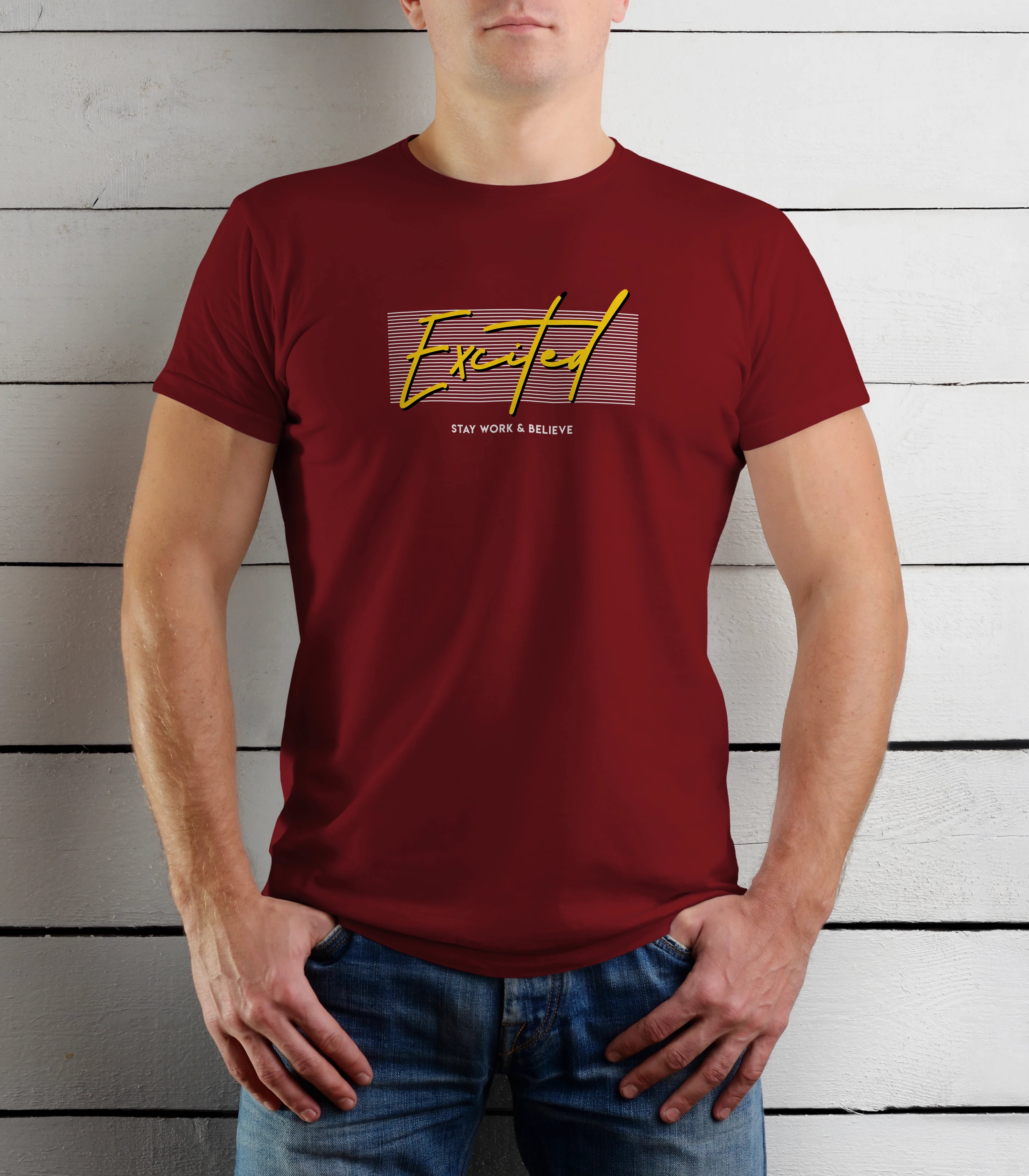 Person wearing a maroon t-shirt with yellow text against a wooden background