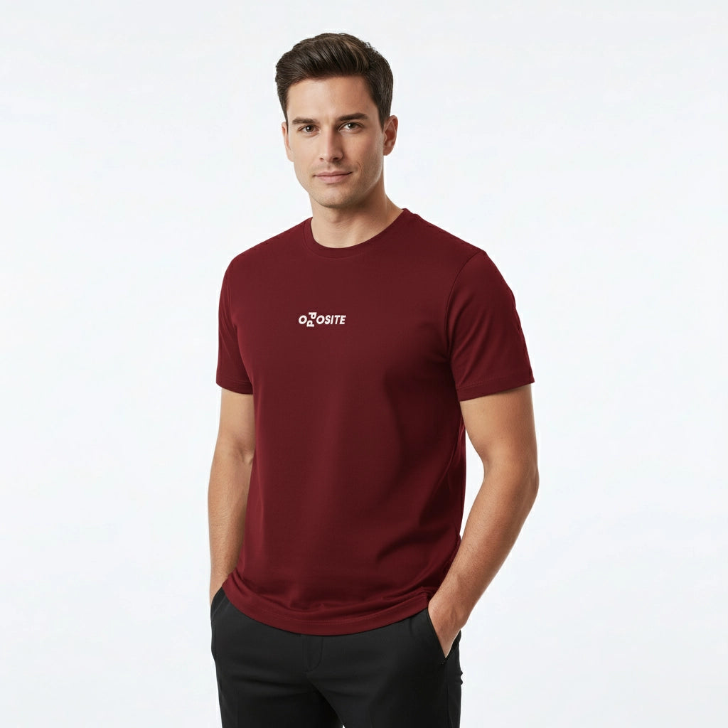 Man wearing a maroon t-shirt with a logo on a white background