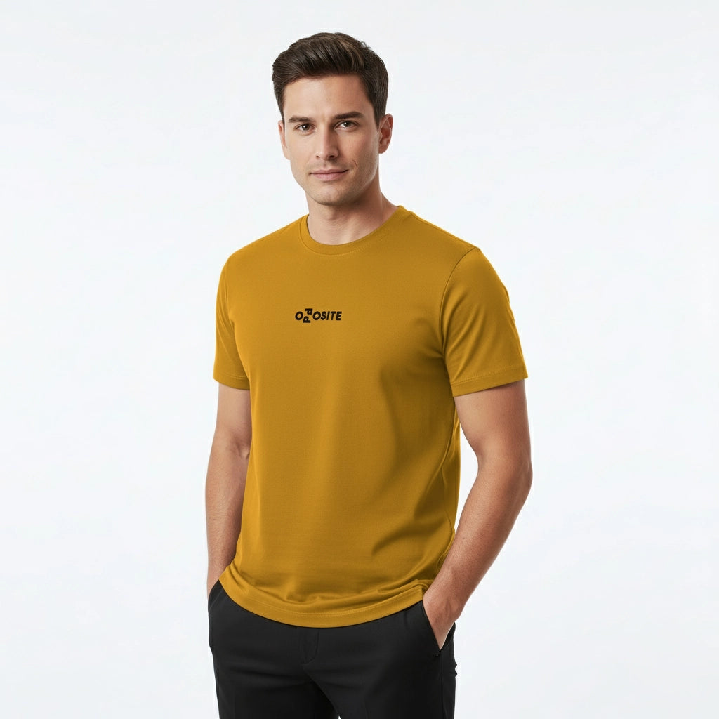 Man wearing a mustard yellow t-shirt with a logo on a white background
