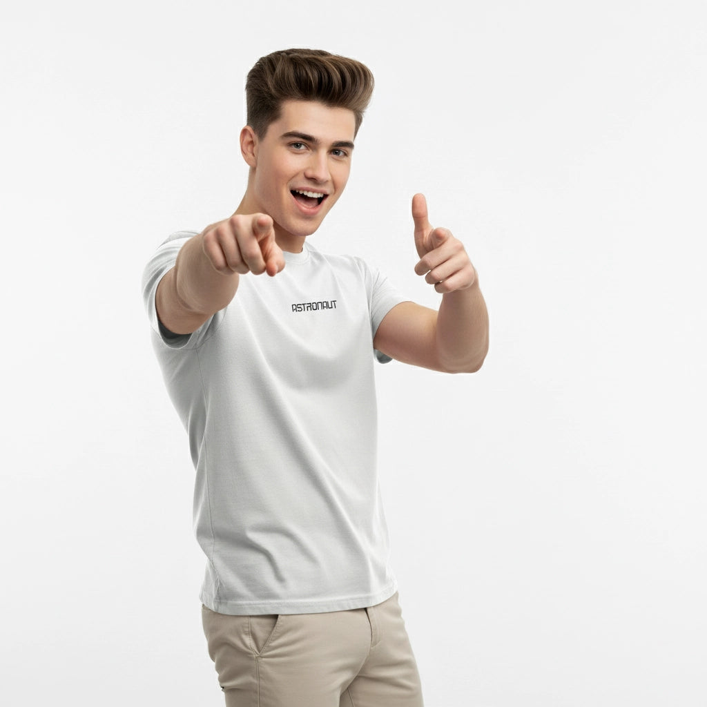 Person wearing a white t-shirt with text, pointing forward on a light gray background