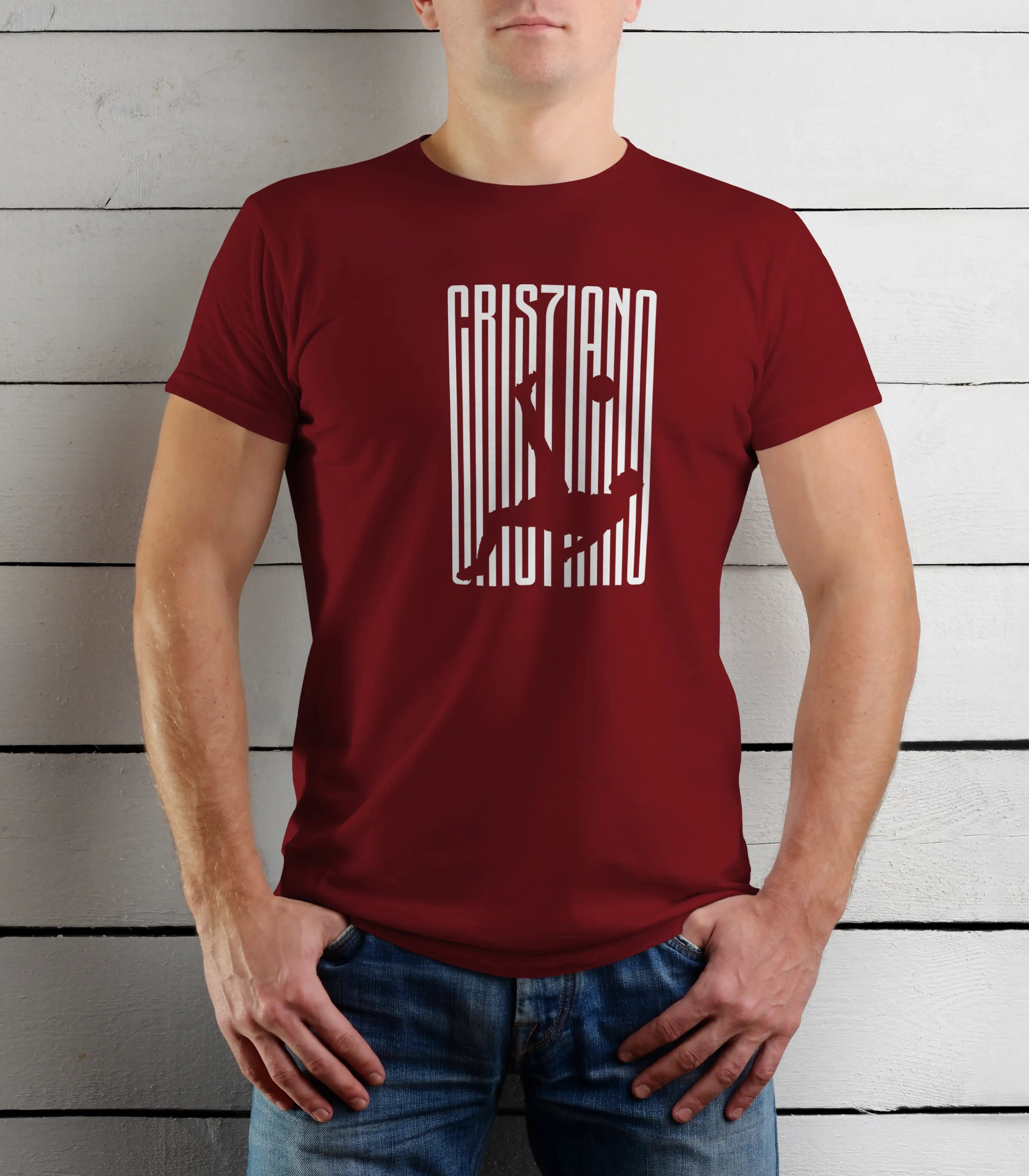 Person wearing a maroon t-shirt with white text against a wooden background