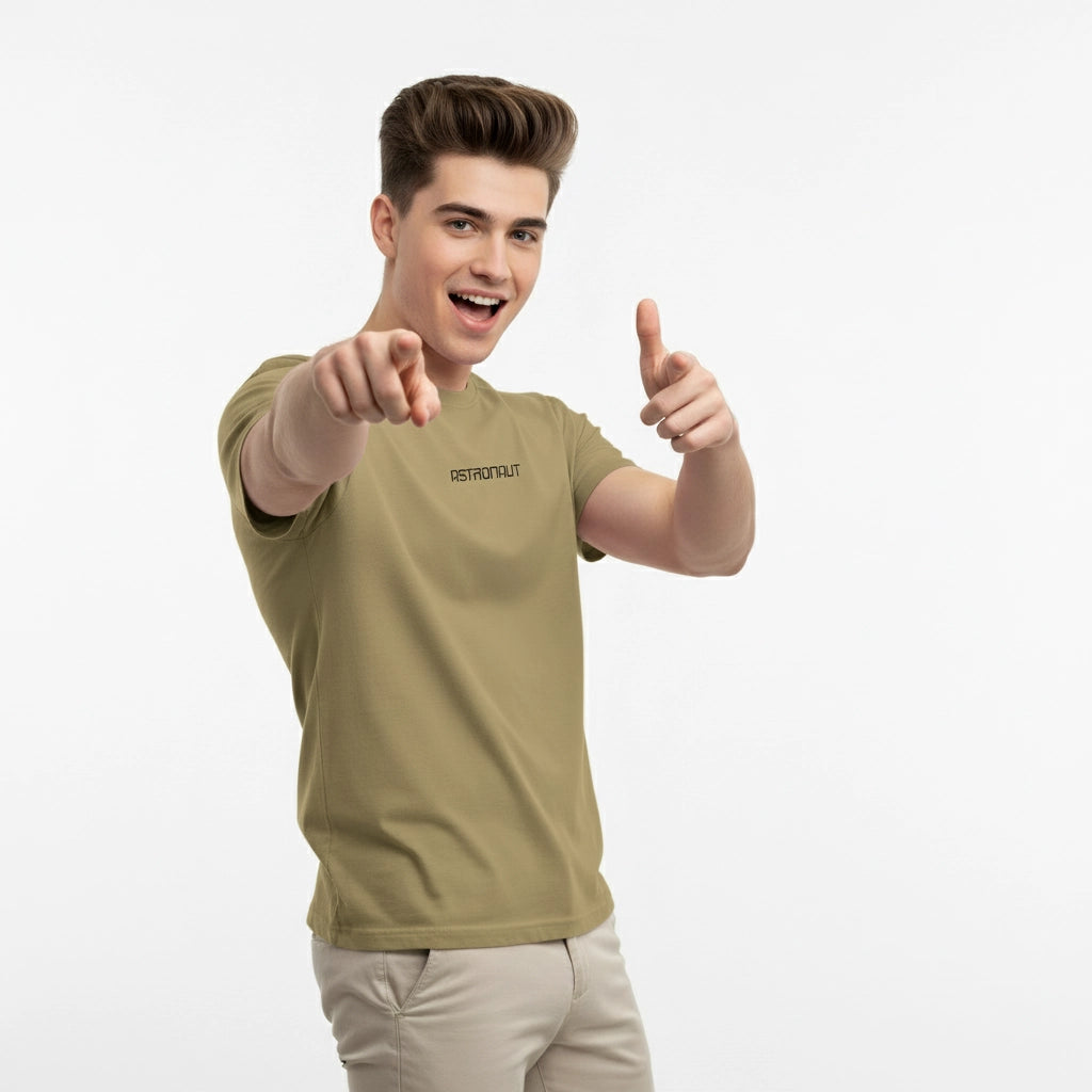 Man wearing a green t-shirt with a brand logo, pointing forward on a white background