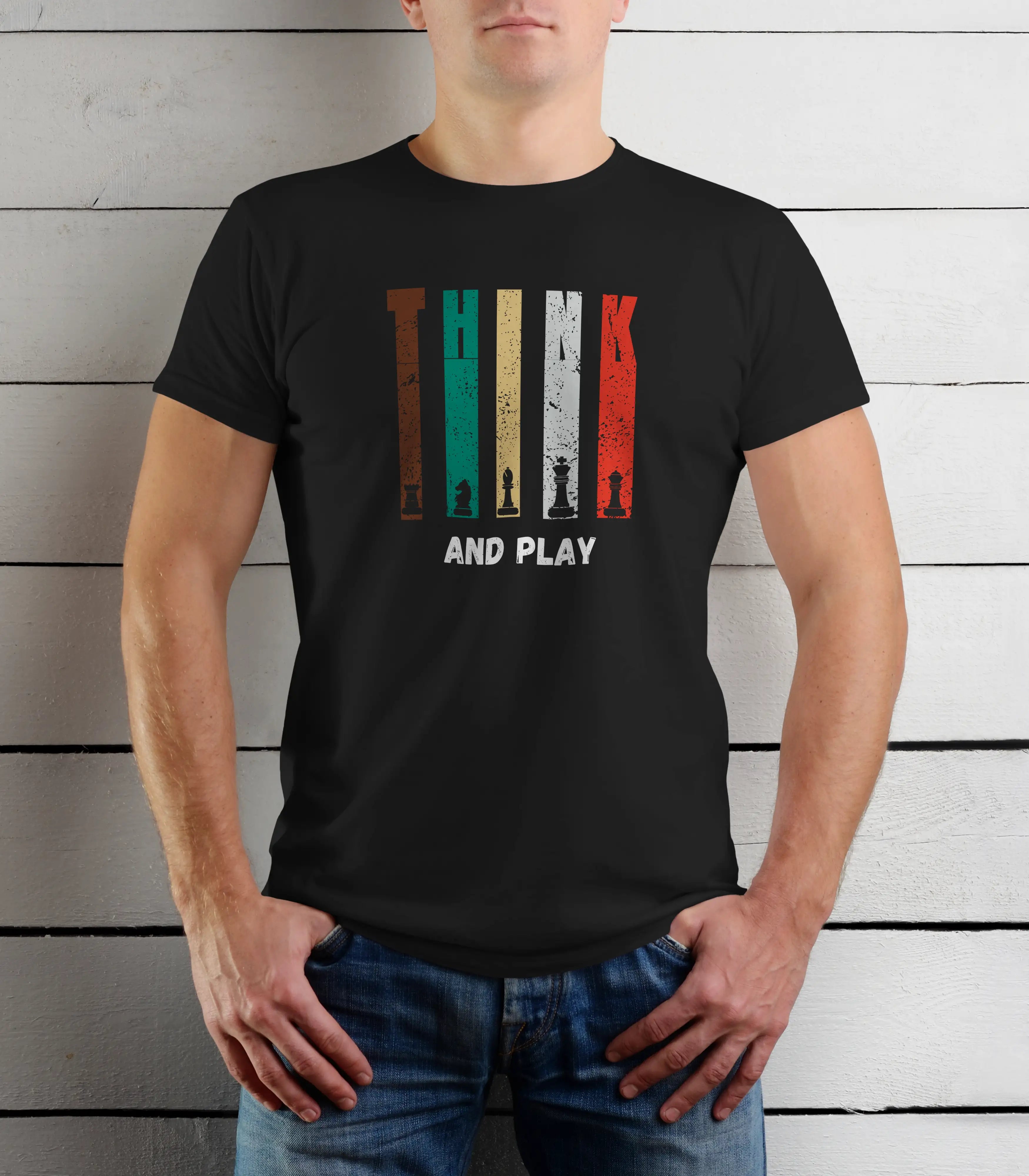 Person wearing a black t-shirt with a colorful graphic design and text against a wooden background