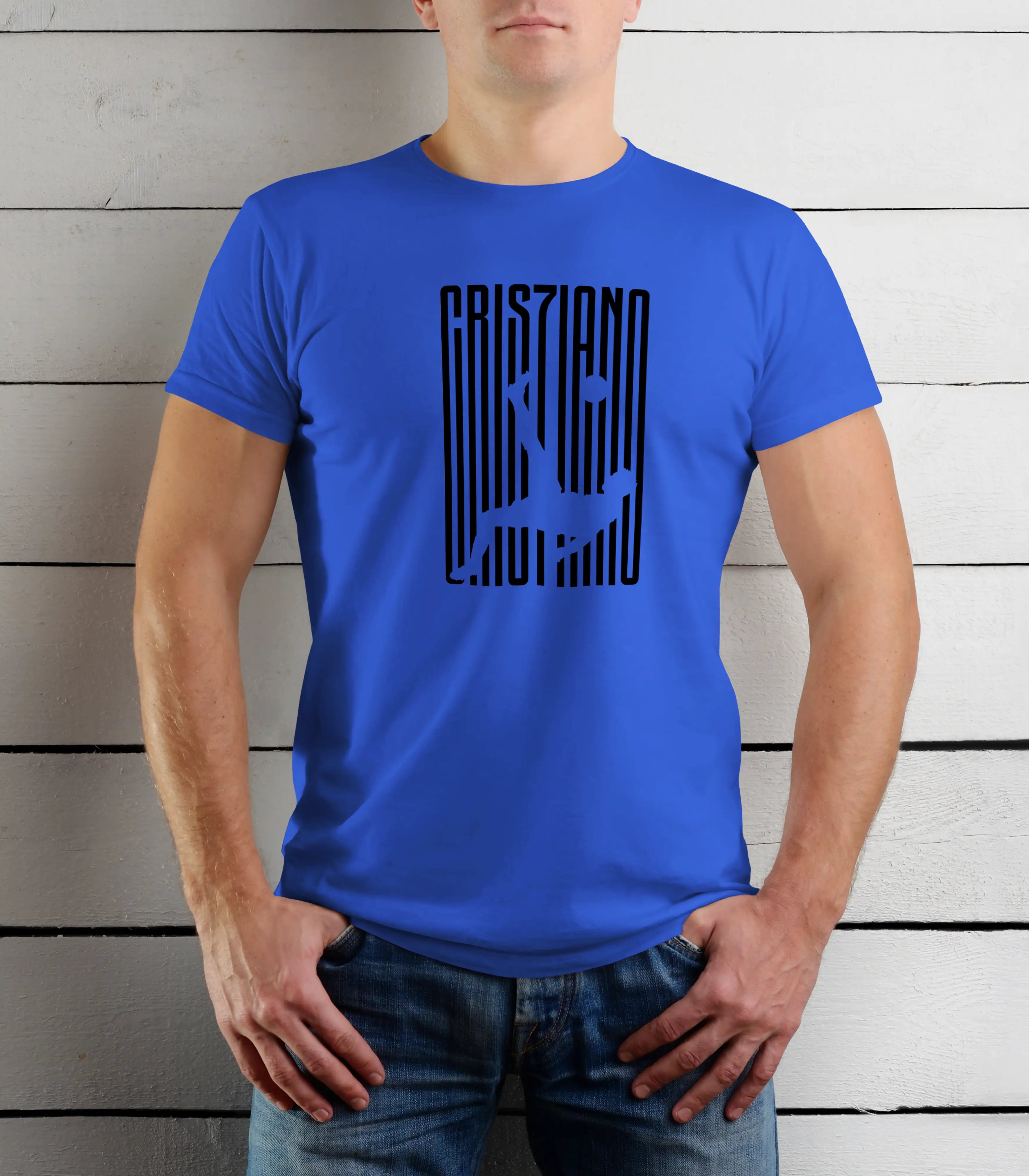 Person wearing a blue t-shirt with black graphic design against a wooden background