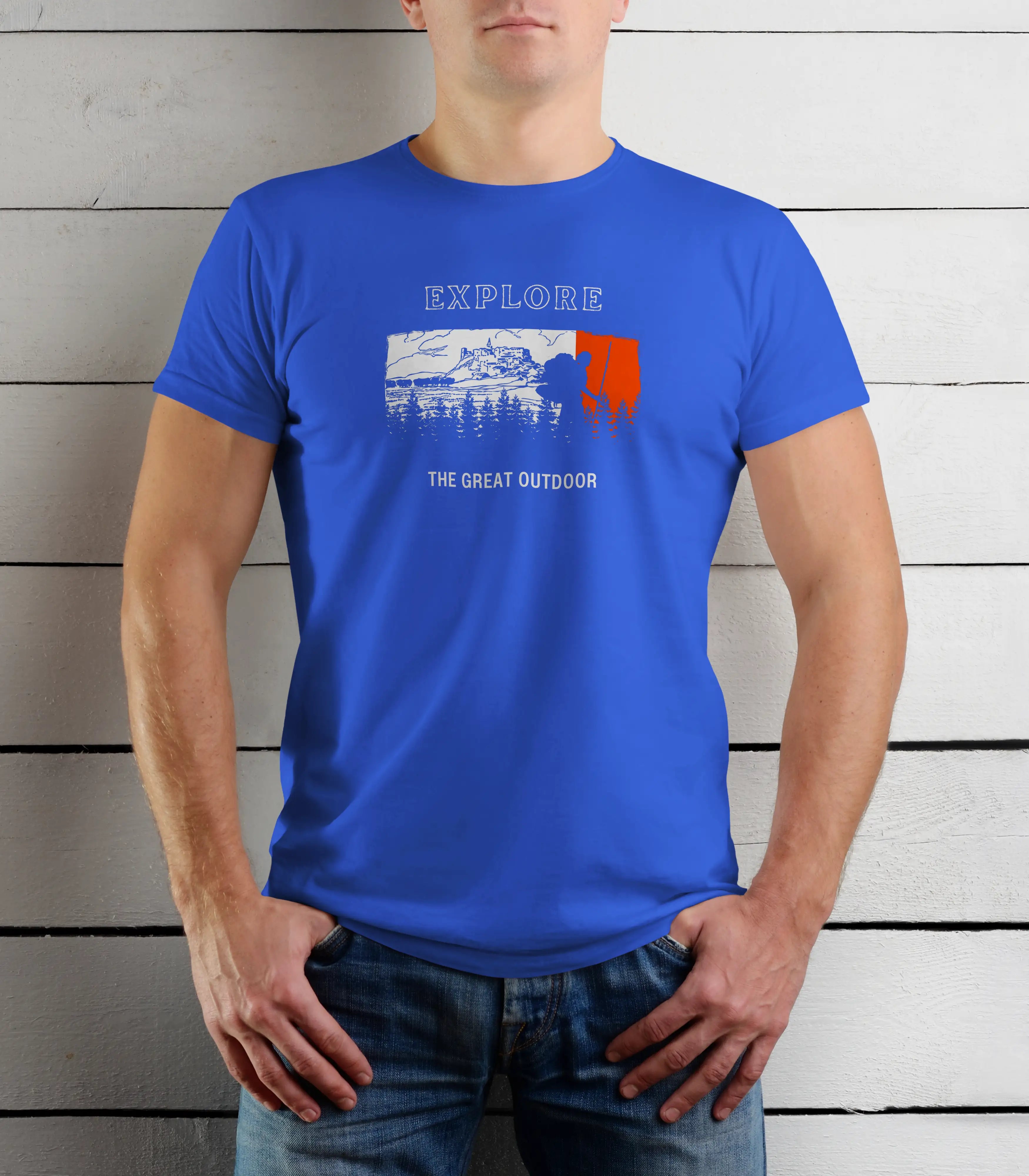 Person wearing a blue t-shirt with 'Explore The Great Outdoor' graphic against a wooden background