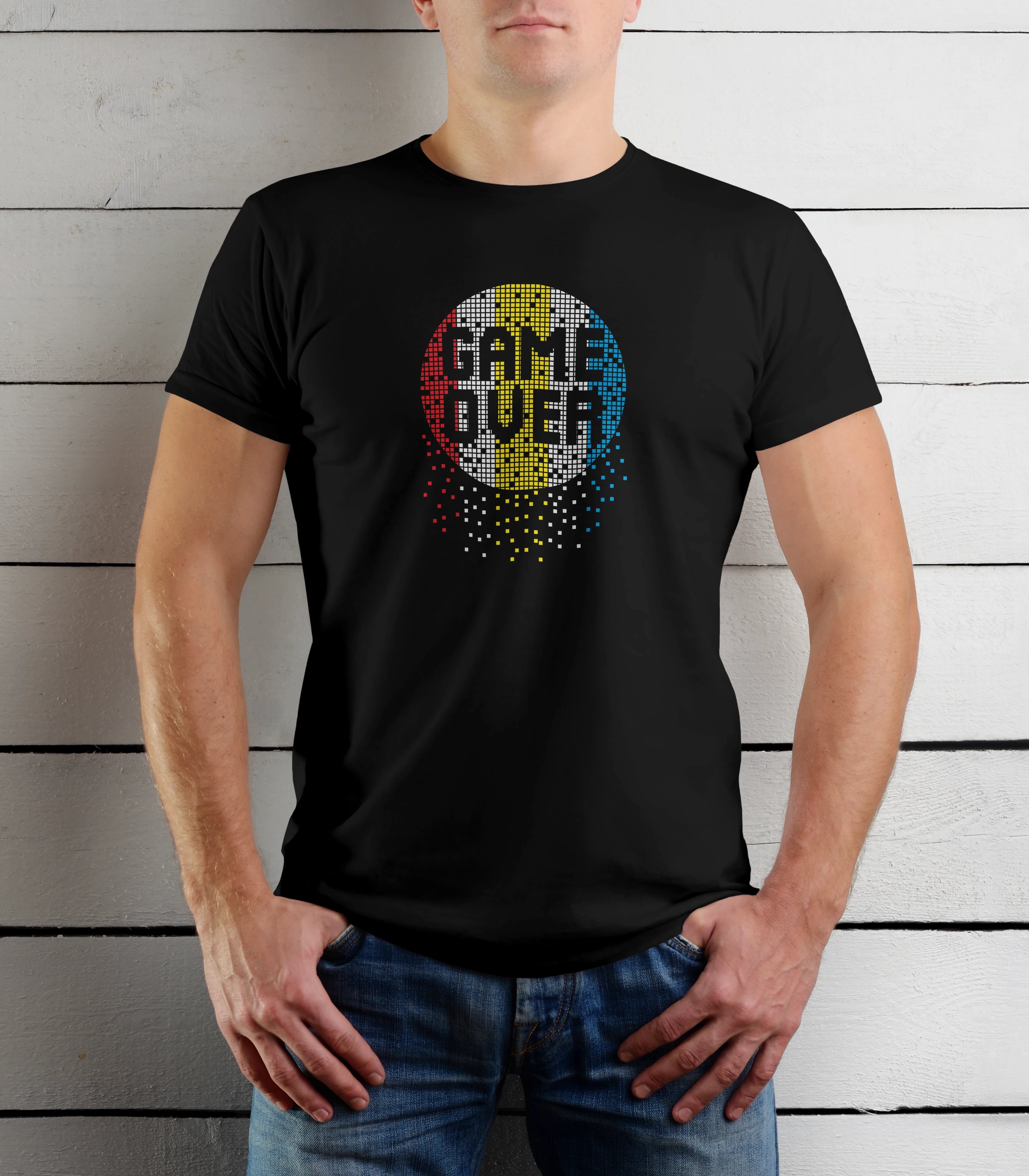Person wearing a black t-shirt with 'Game Over' design against a wooden background