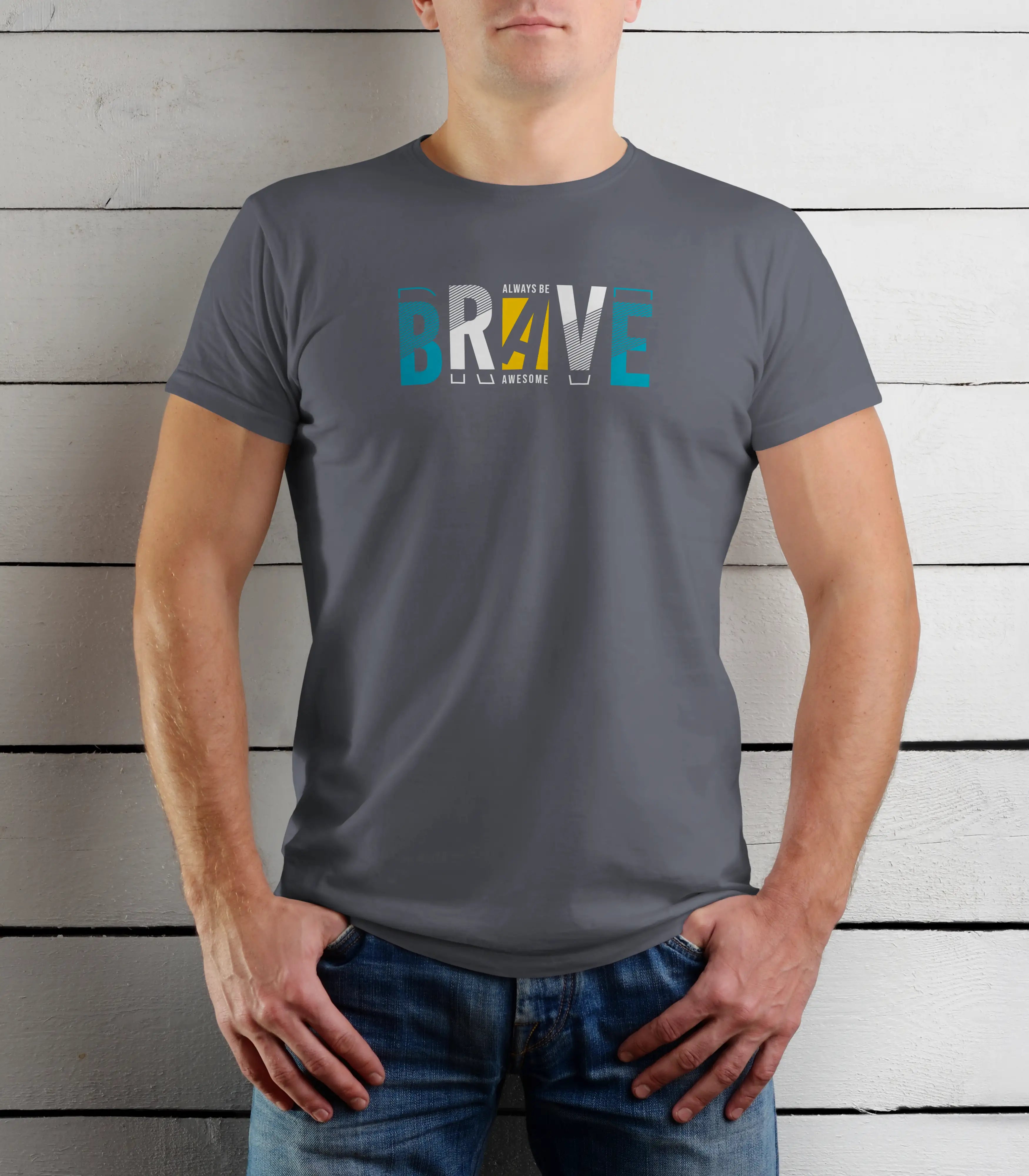 Person wearing a gray t-shirt with colorful text design against a wooden background