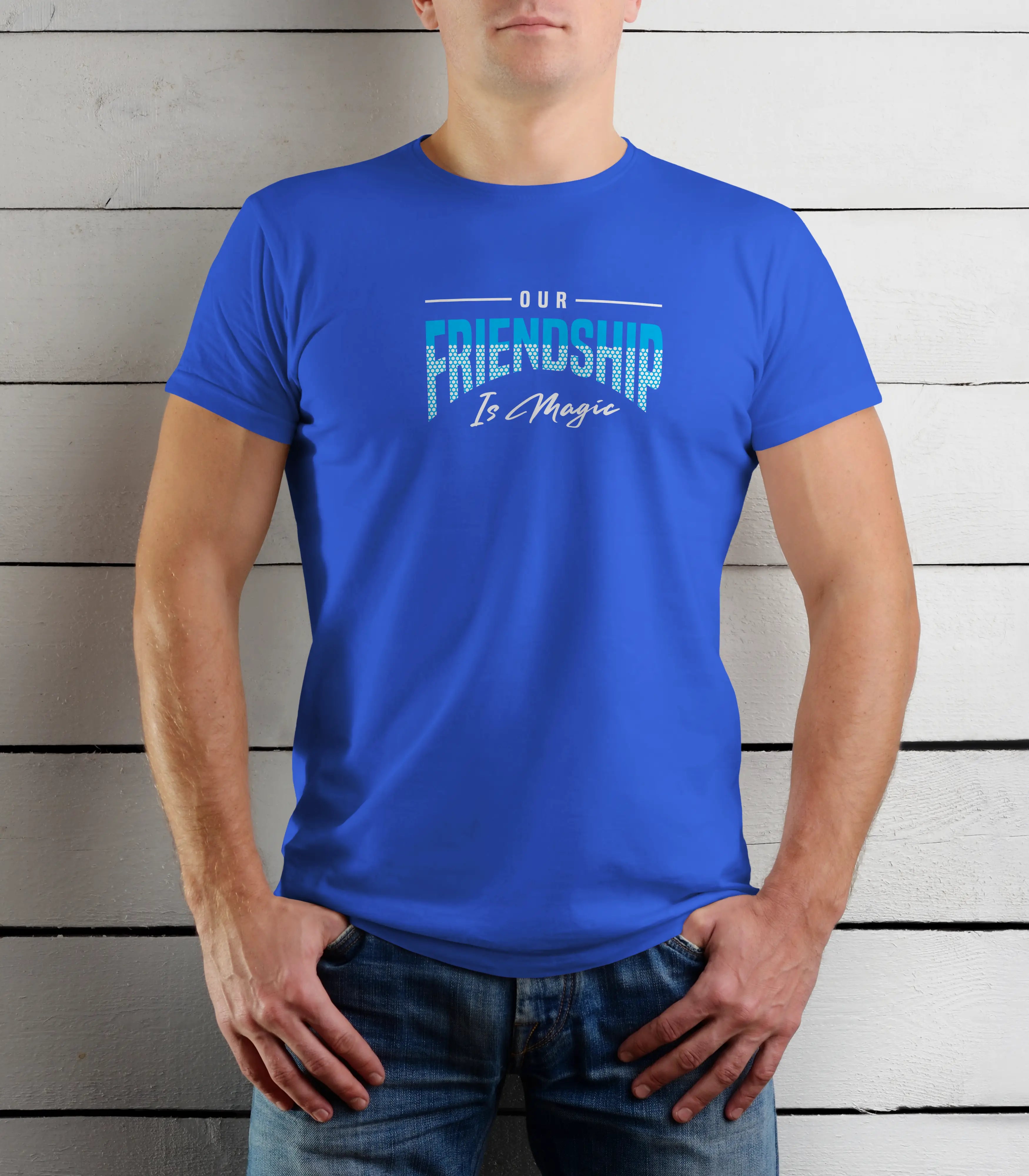 Person wearing a blue t-shirt with 'Our Friendship Is Magic' text against a wooden background