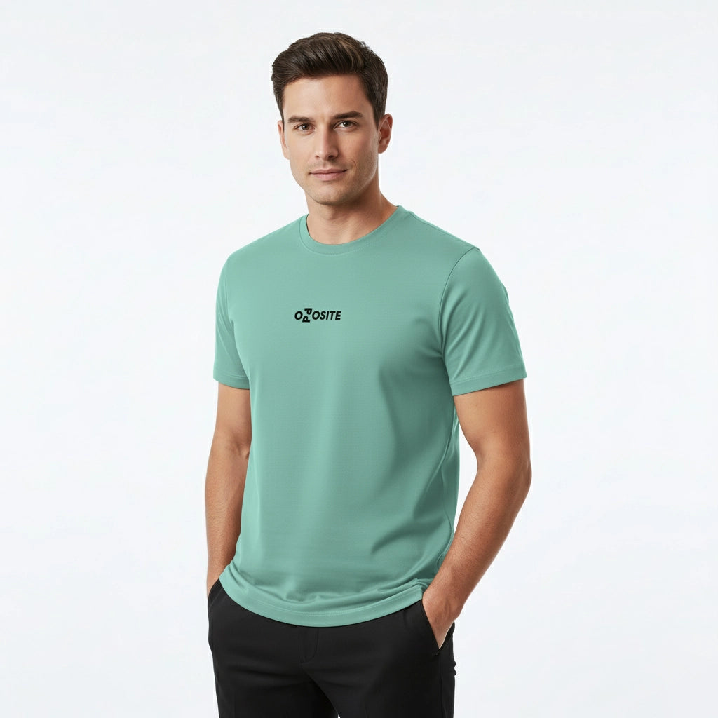 Man wearing a light green t-shirt with a logo on a white background