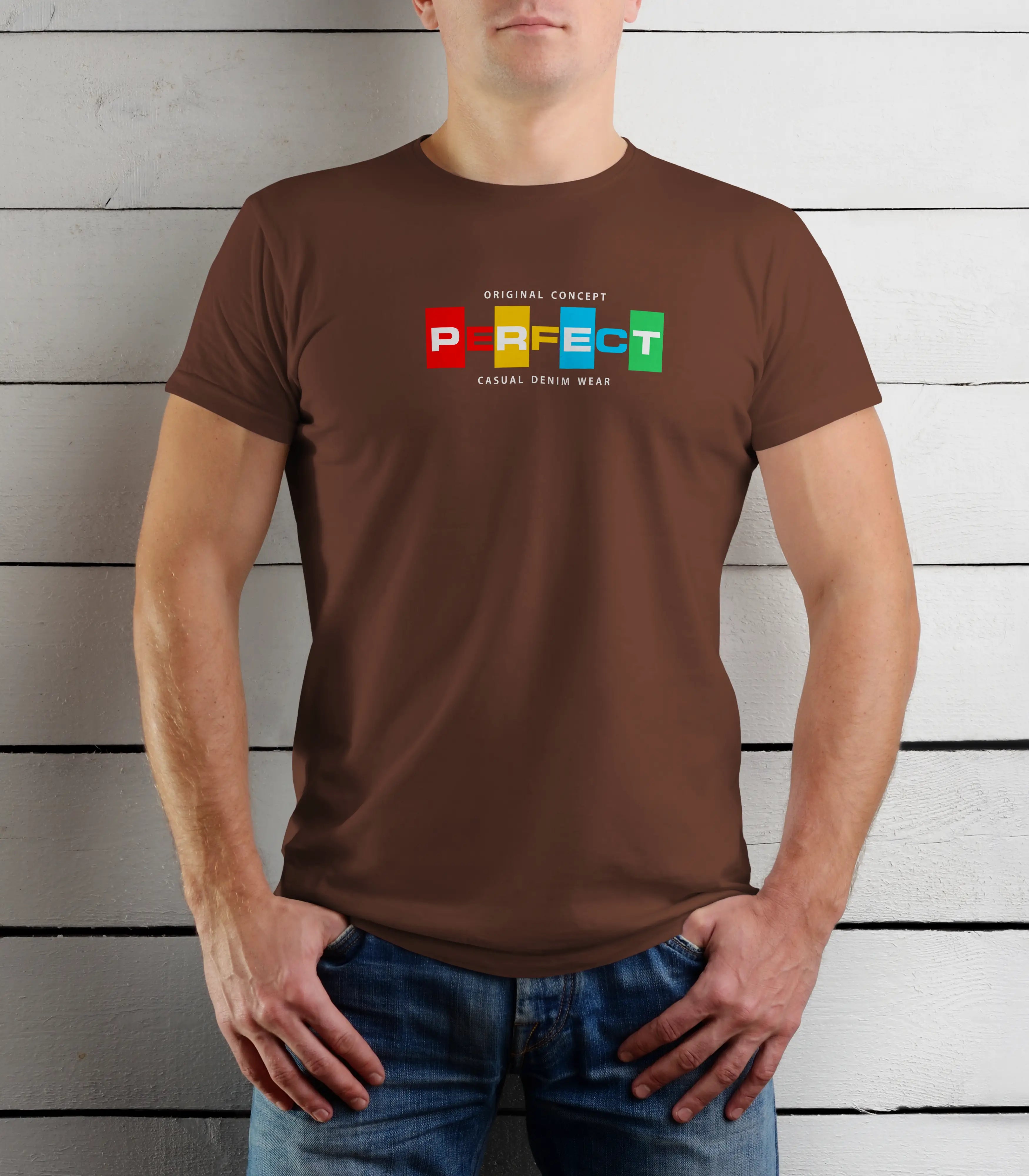 Person wearing a brown t-shirt with colorful text design against a wooden background