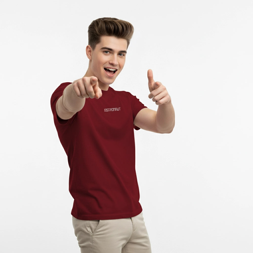 Person wearing a red t-shirt with a logo, pointing forward on a white background