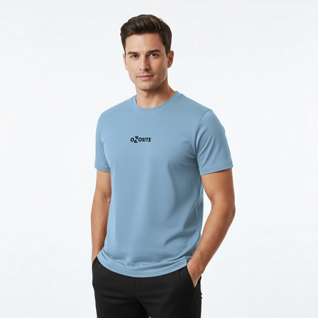 Man wearing a light blue t-shirt with a logo on a white background