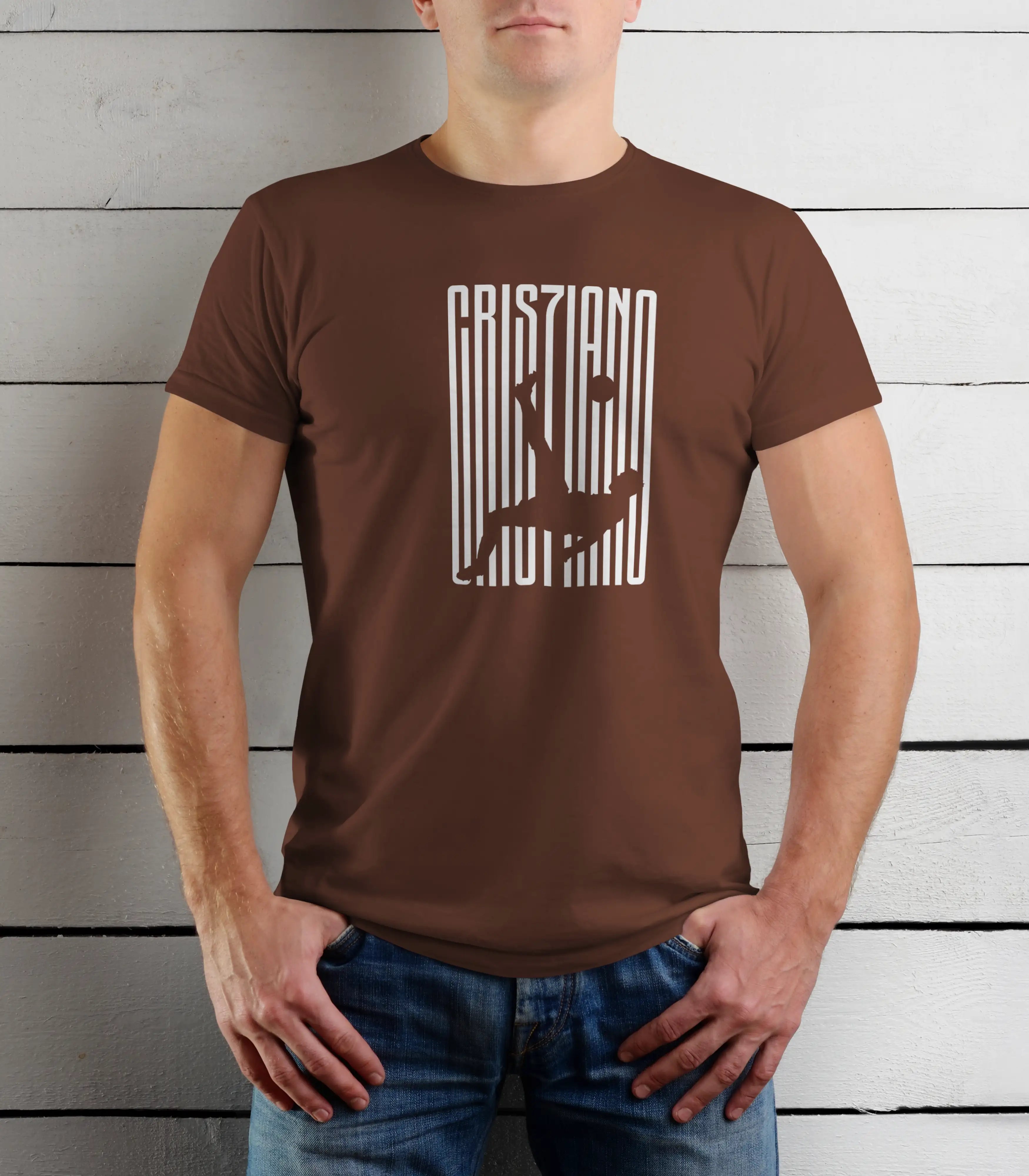 Person wearing a brown t-shirt with white text against a wooden background