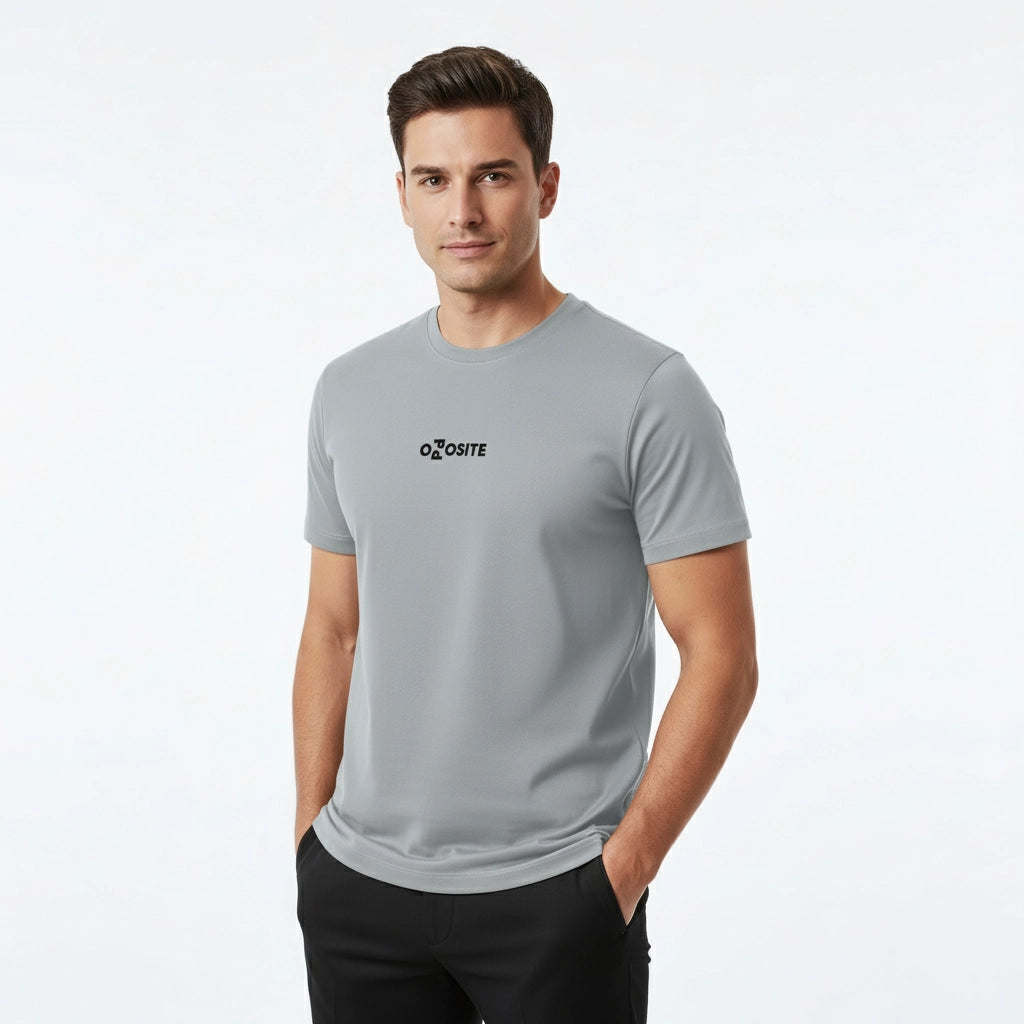 Man wearing a gray t-shirt with a logo on a white background