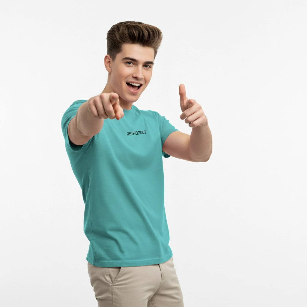 Person wearing a teal t-shirt with a logo, giving a thumbs-up gesture on a white background