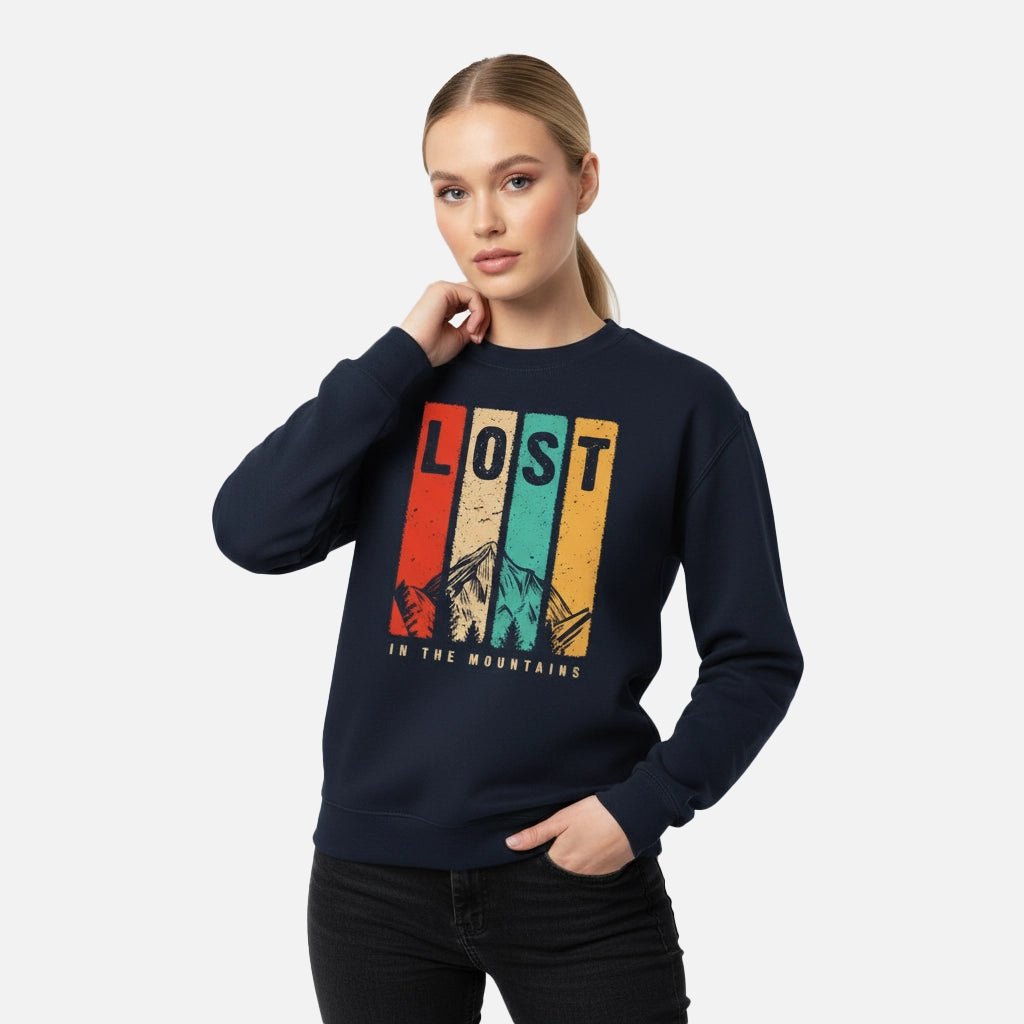 Woman wearing a navy blue sweatshirt with 'Lost in the Mountains' graphic design on a white background