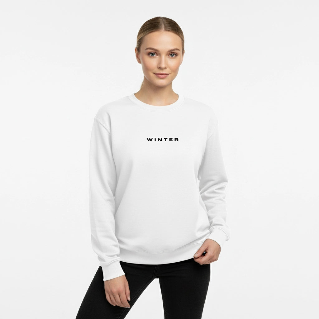 Woman wearing a white sweatshirt with 'WINTER' text on a light gray background