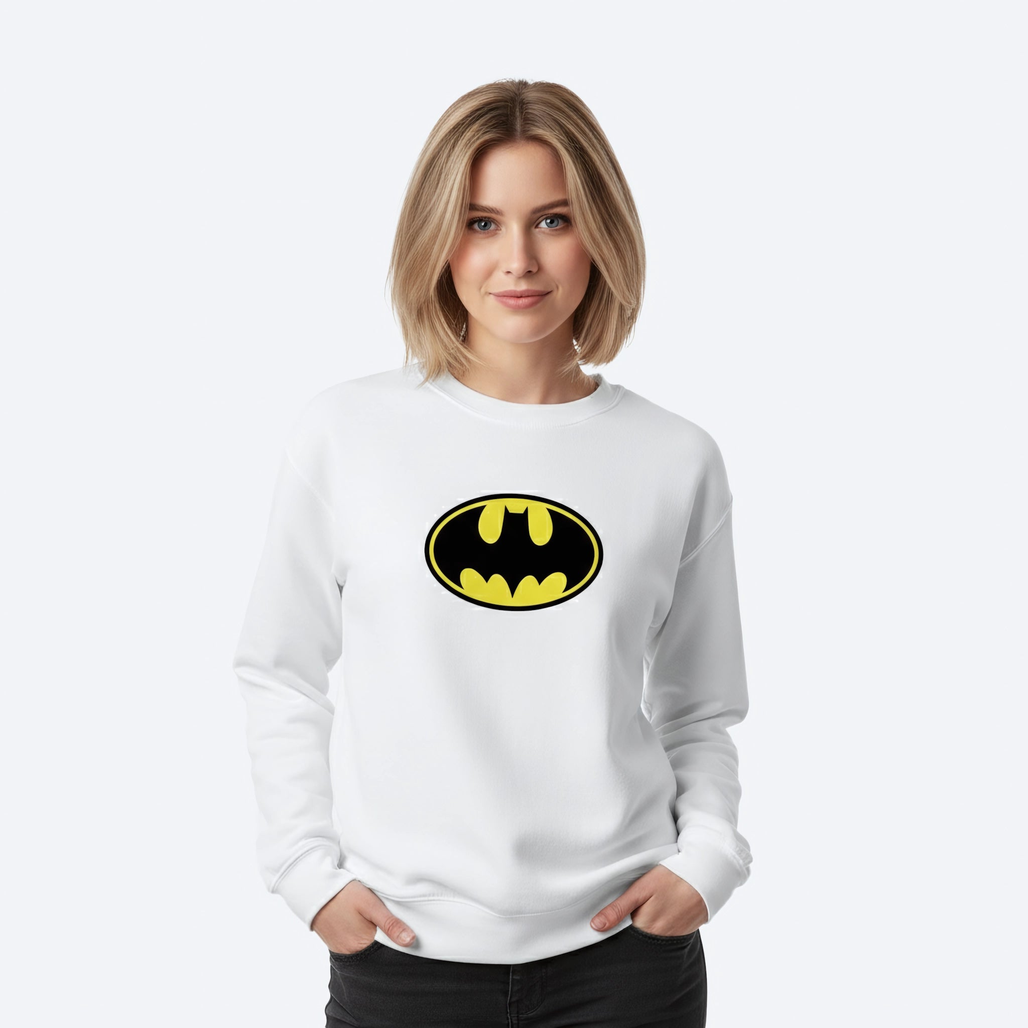Woman wearing a white sweatshirt with a Batman logo on a white background