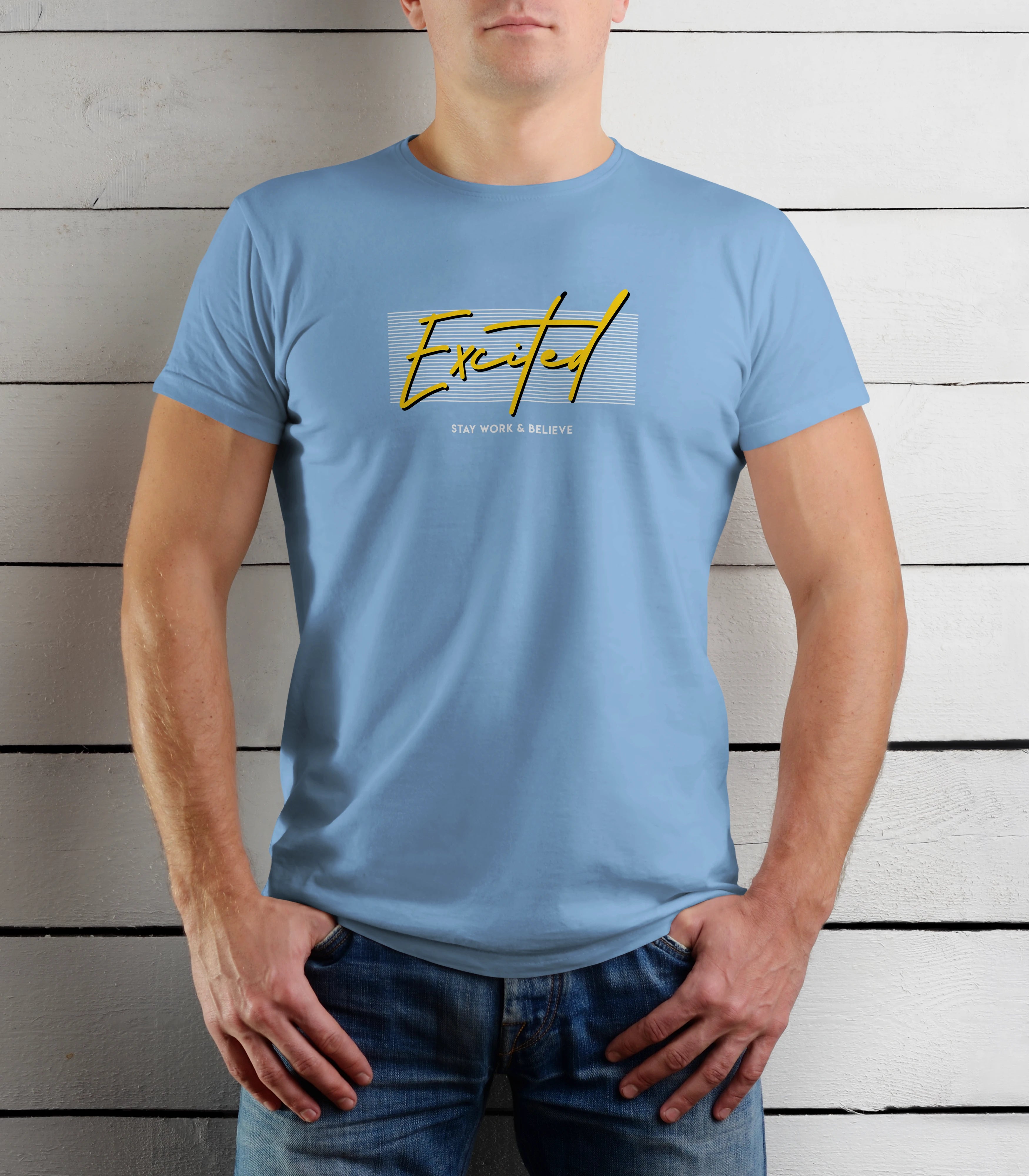 Person wearing a light blue t-shirt with yellow text against a wooden background