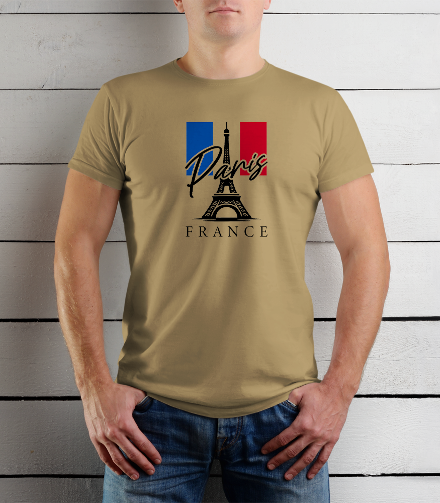 Person wearing a beige t-shirt with Paris and France design against a wooden background