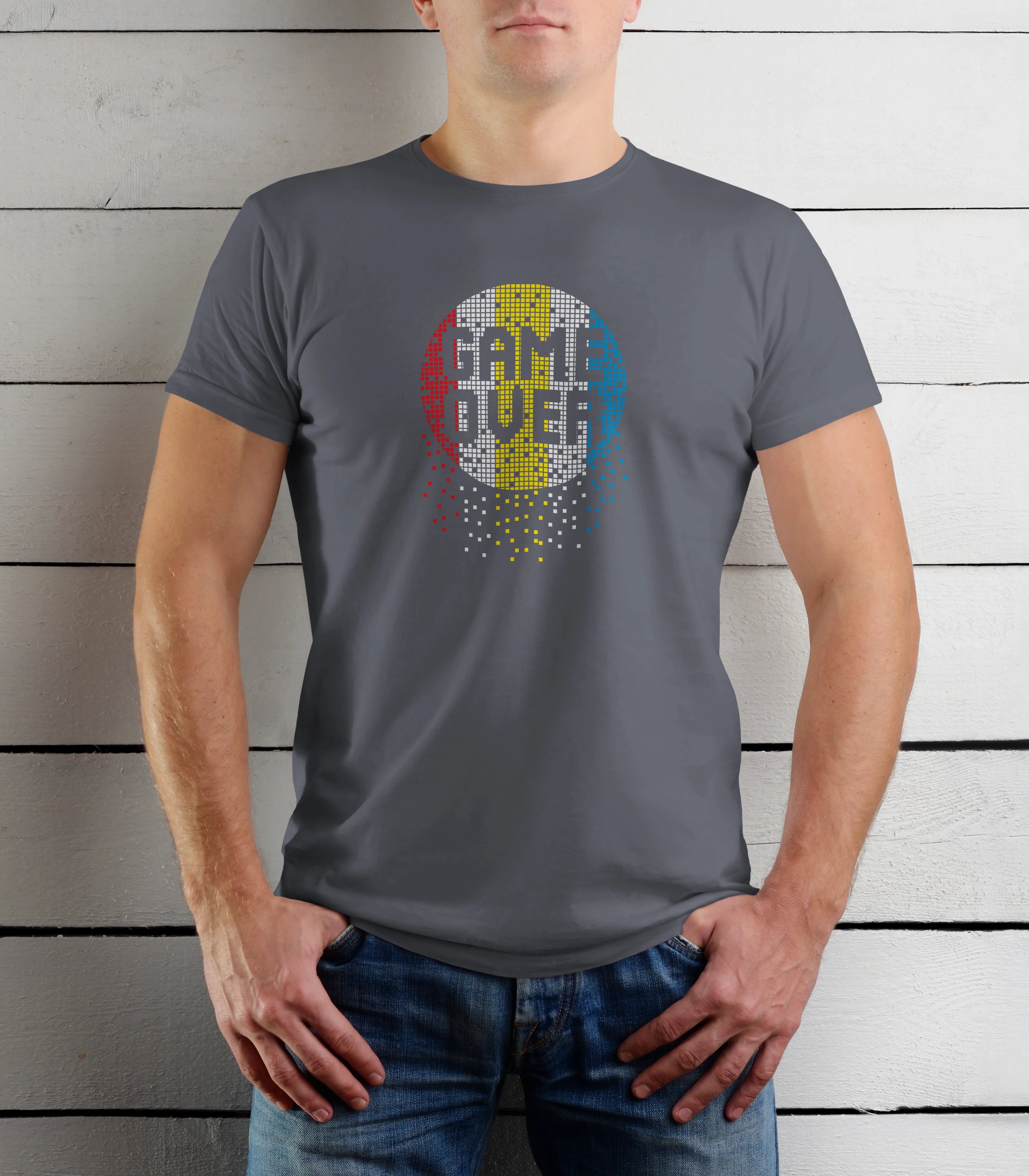 Person wearing a gray t-shirt with a colorful graphic design against a wooden background