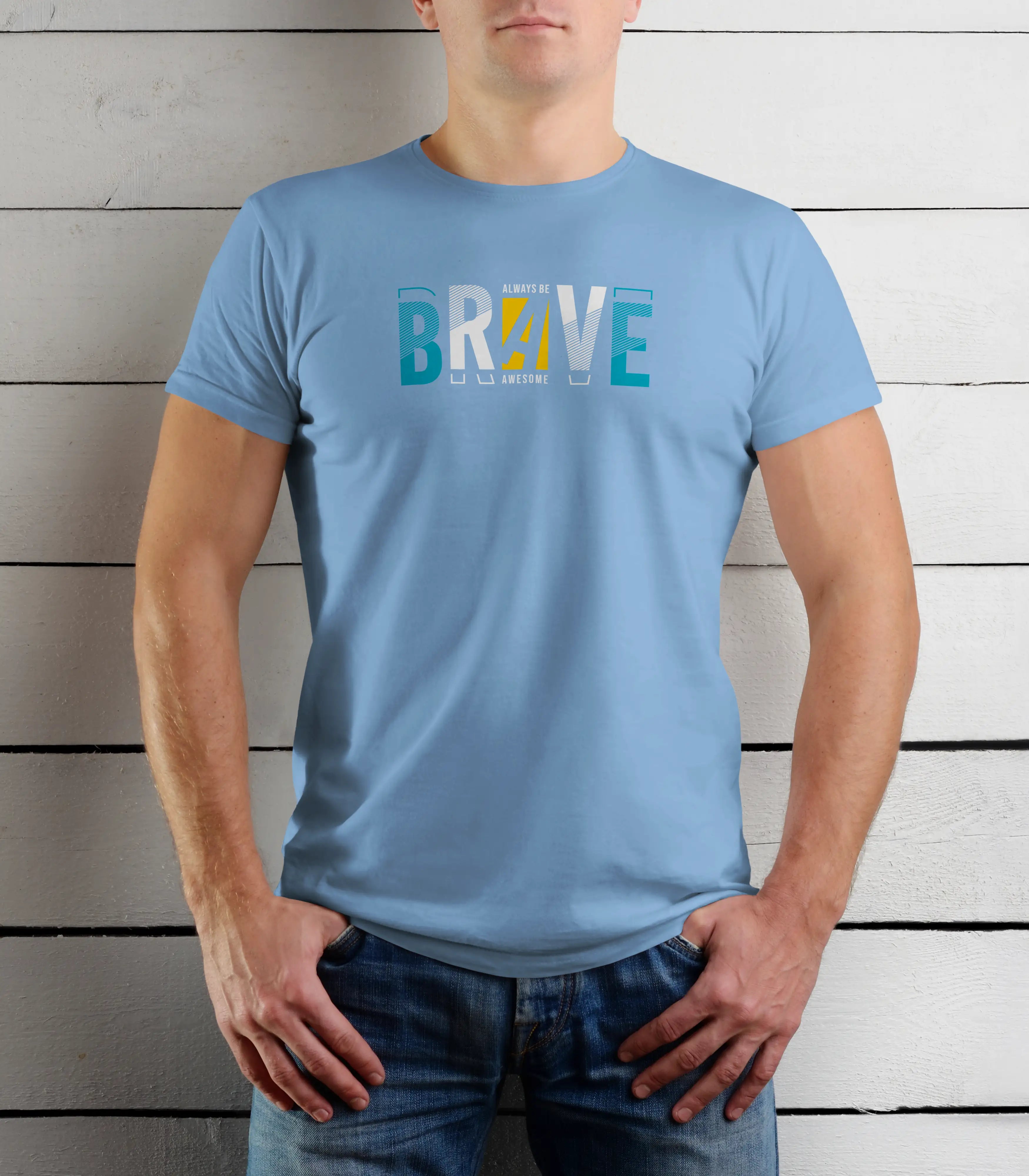 Person wearing a light blue t-shirt with 'BRAVE' printed on it against a wooden background