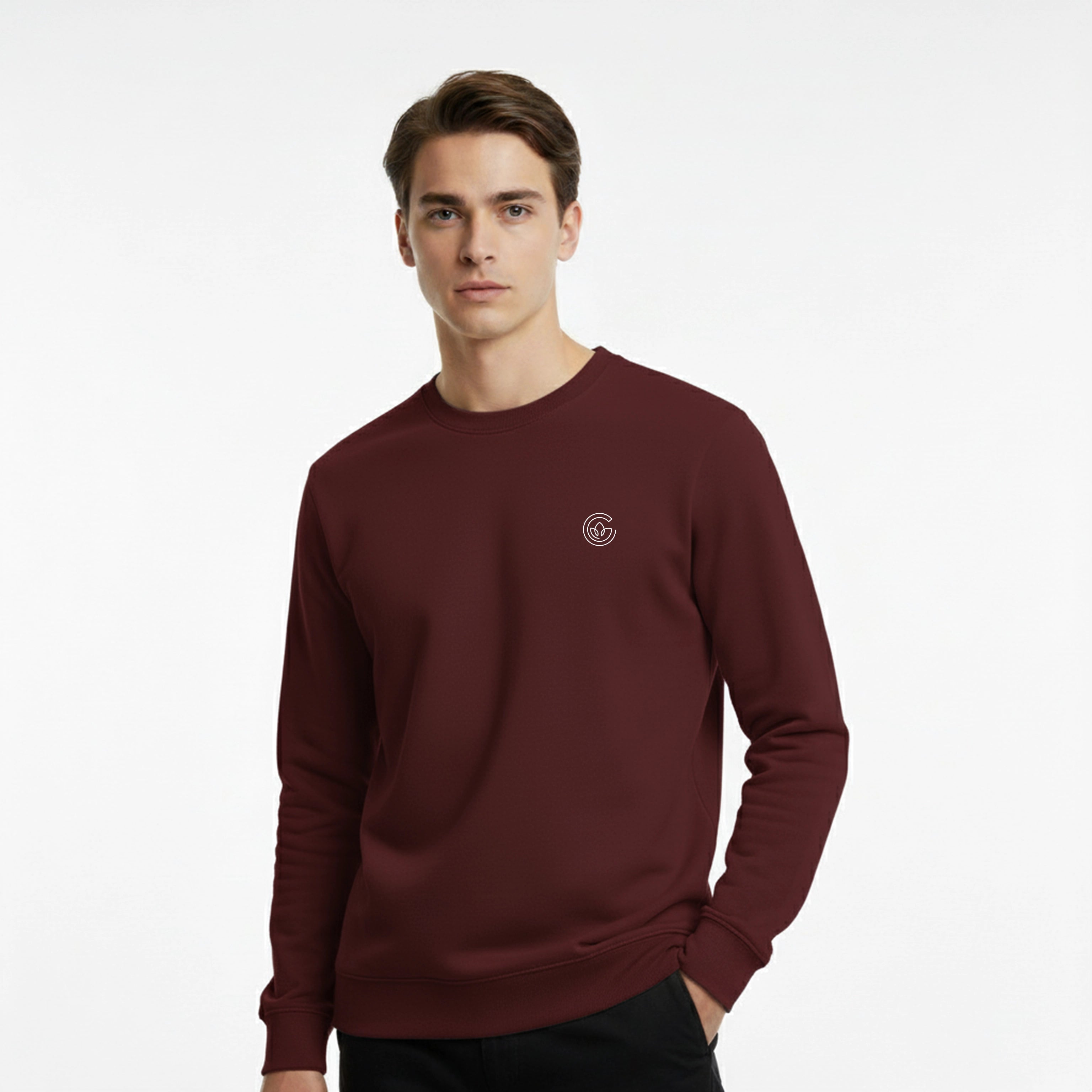 Man wearing a maroon sweatshirt with a small logo on a white background