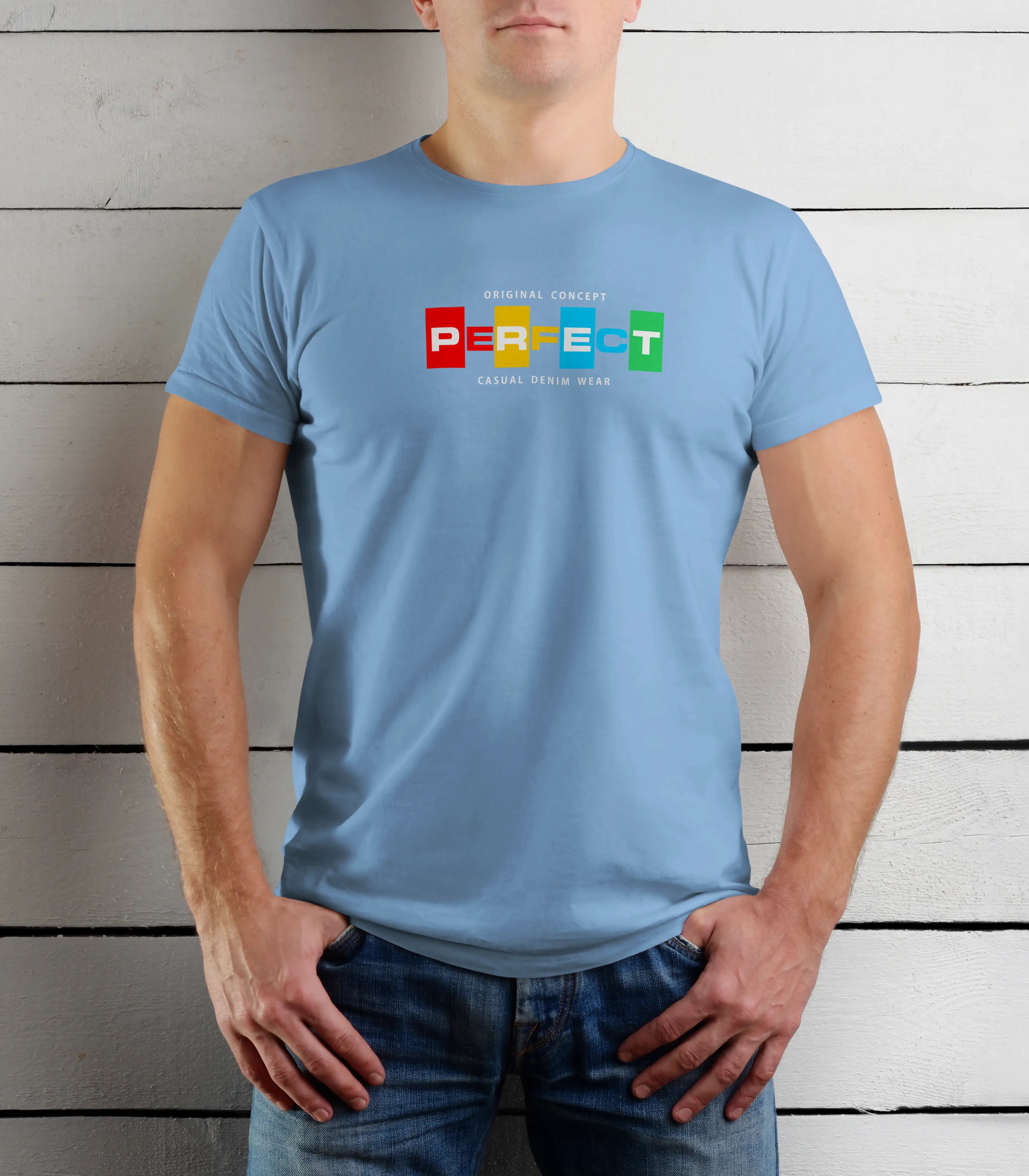 Person wearing a light blue t-shirt with colorful text design against a wooden background